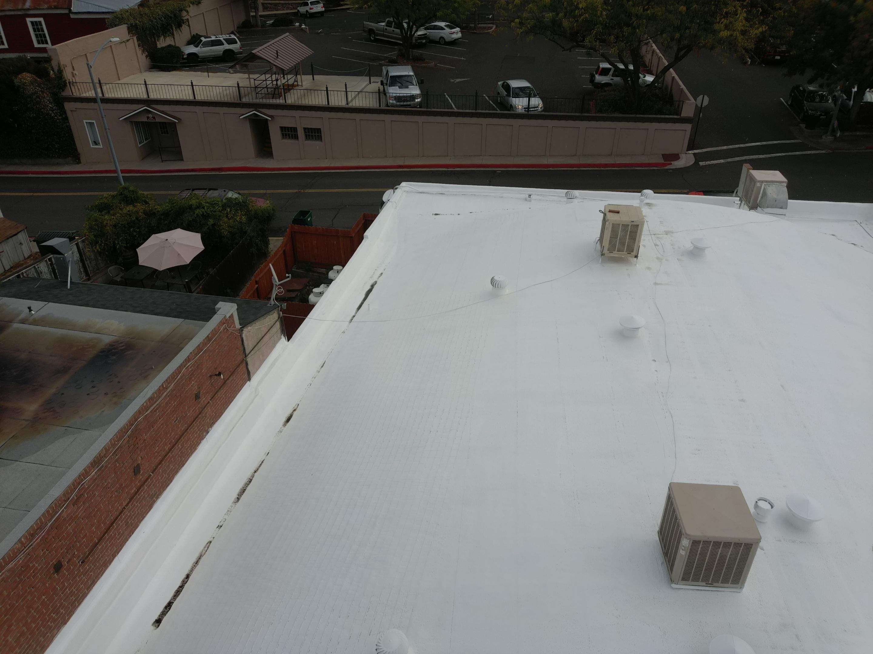 Foam and coatings on commercial roof by Straight Edge Roofing Inc