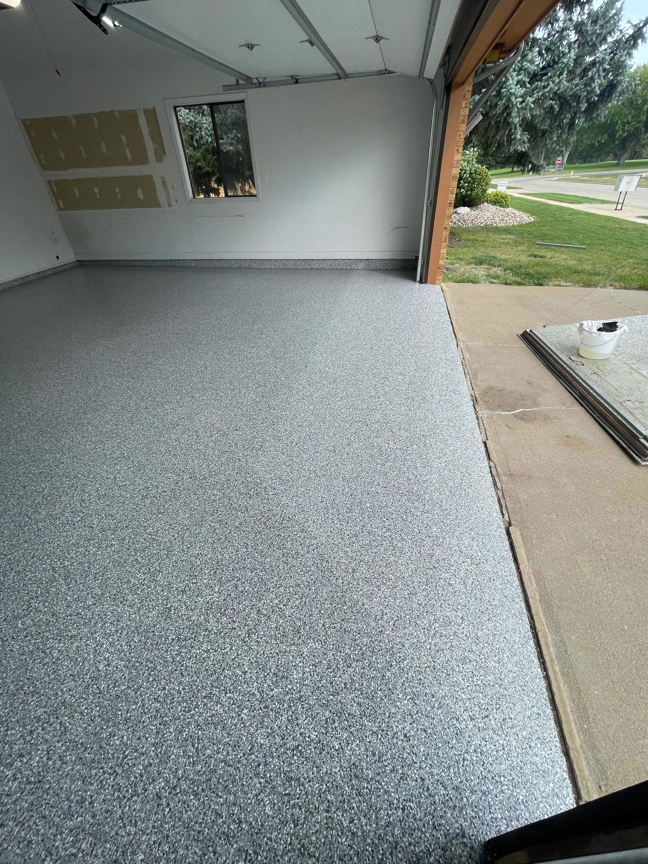 Grey Speckled Concrete Coating for Residential Garage in Yankton by Select Painting, Coatings & Garage Cabinets