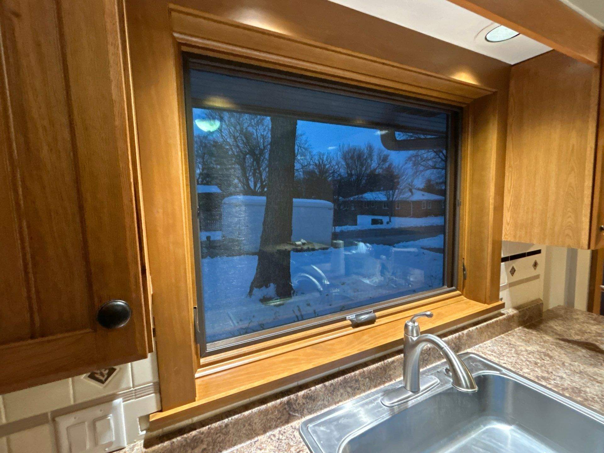 Black-Frame Pella Lifestyle Upgrade on a Partial Brick Home by United Windows and Siding LLC