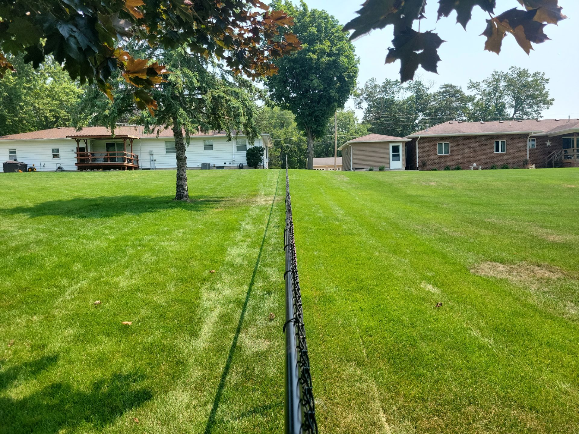Black Vinyl-Coated Chain Link Fence Installation in New Hampton by Perfect Picket Fence and Stain