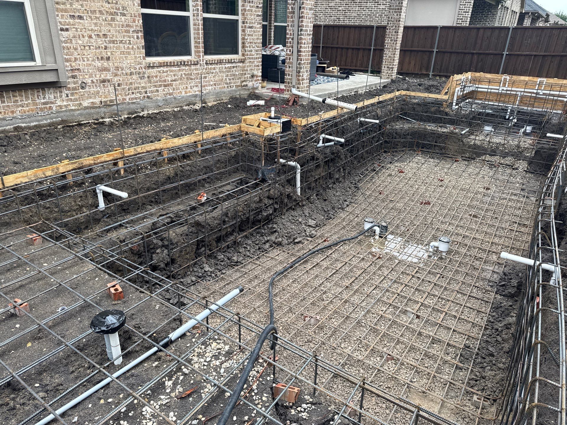 Modern Geometric Pool with Tile Waterfall Wall and Fire Bowls by Pinnacle Pools and Spas - DFW