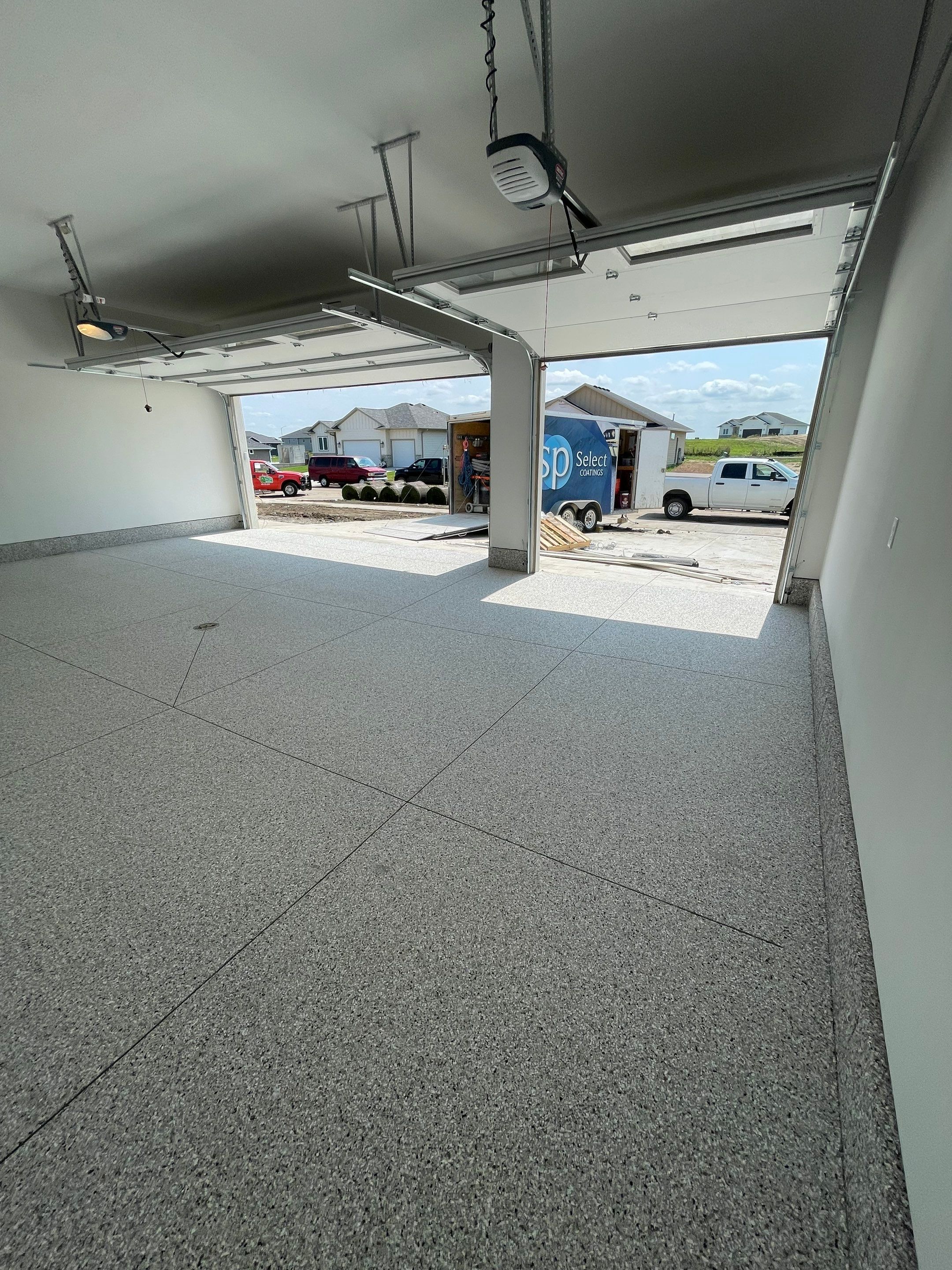 Grey Speckled Garage Floor Coating in Sioux Falls by Select Painting, Coatings & Garage Cabinets