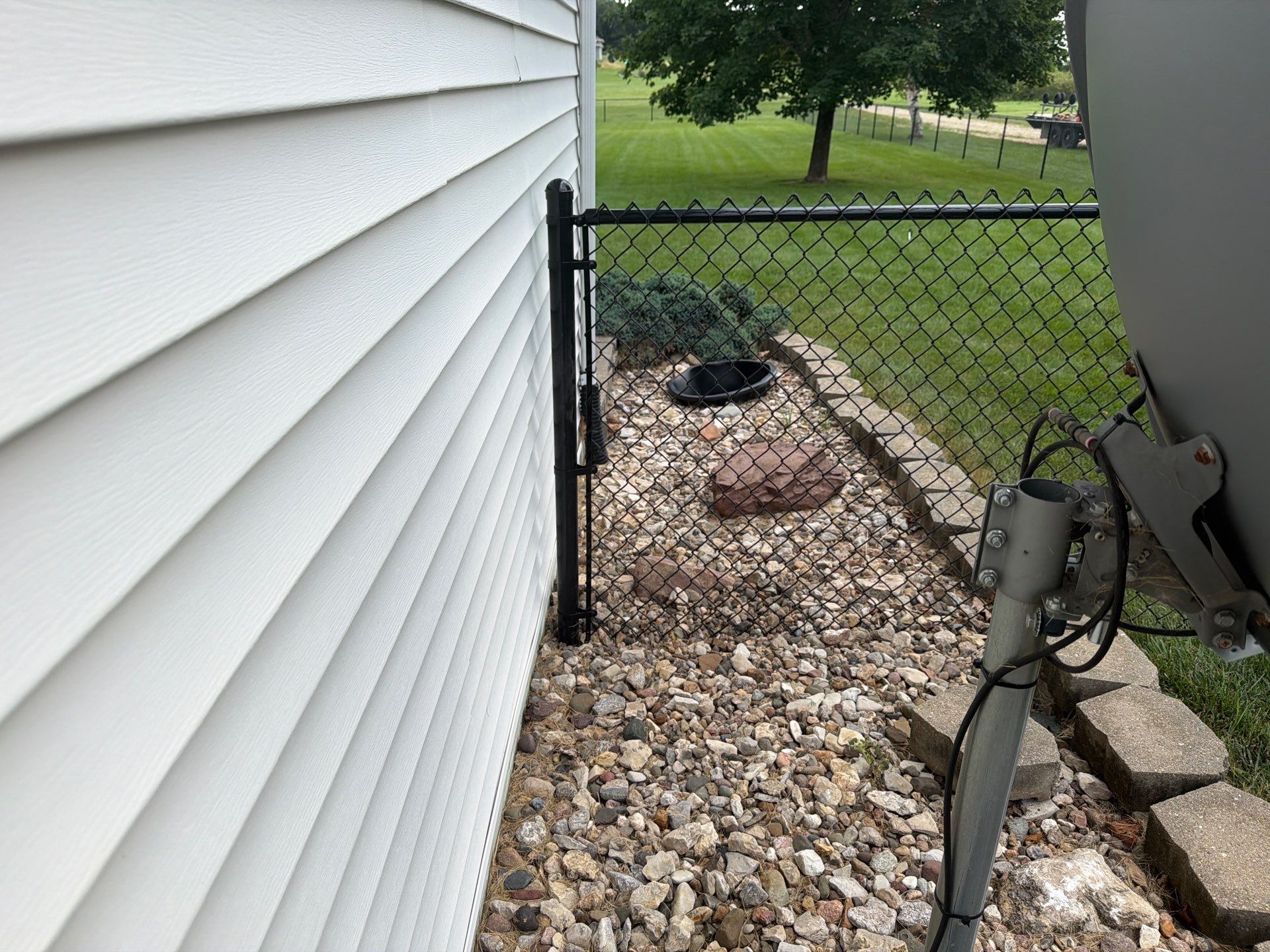 Black Vinyl-Coated Chain Link Fence Installation in Fairbank by Perfect Picket Fence and Stain