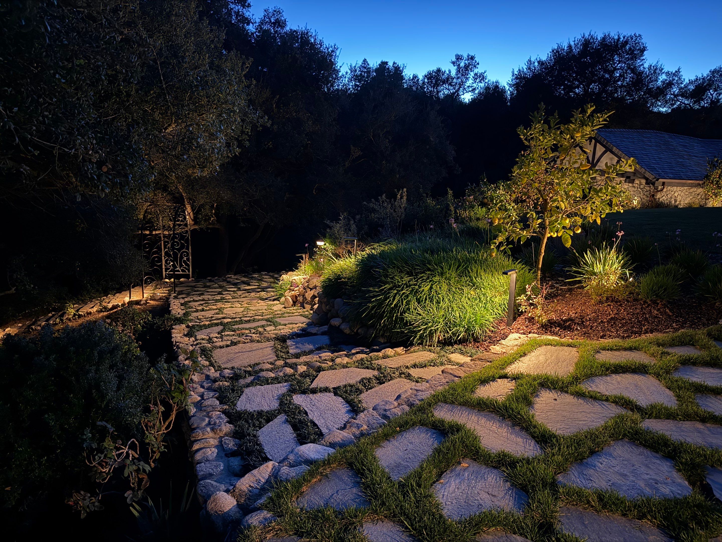 Tudor Estate Landscape Lighting with Integrated Stone Step Illumination by Outdoor Lights + Shades