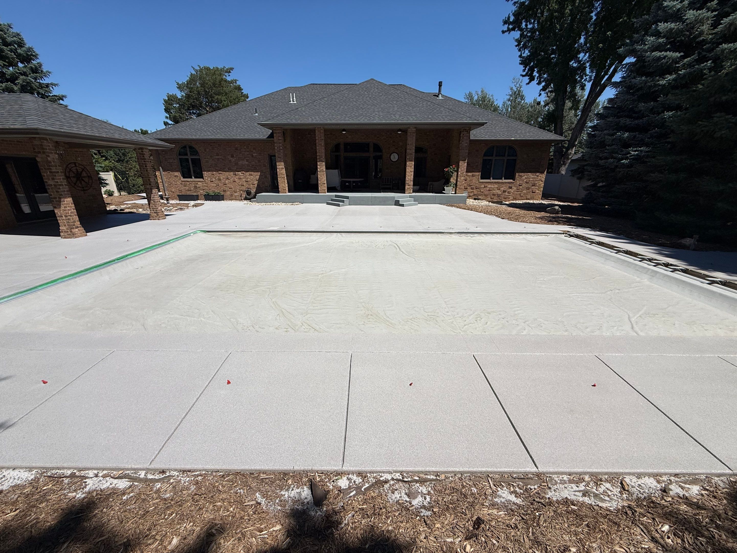 Decorative Concrete Pool Deck and Patio Resurfacing in Sioux Falls by Select Painting, Coatings & Garage Cabinets