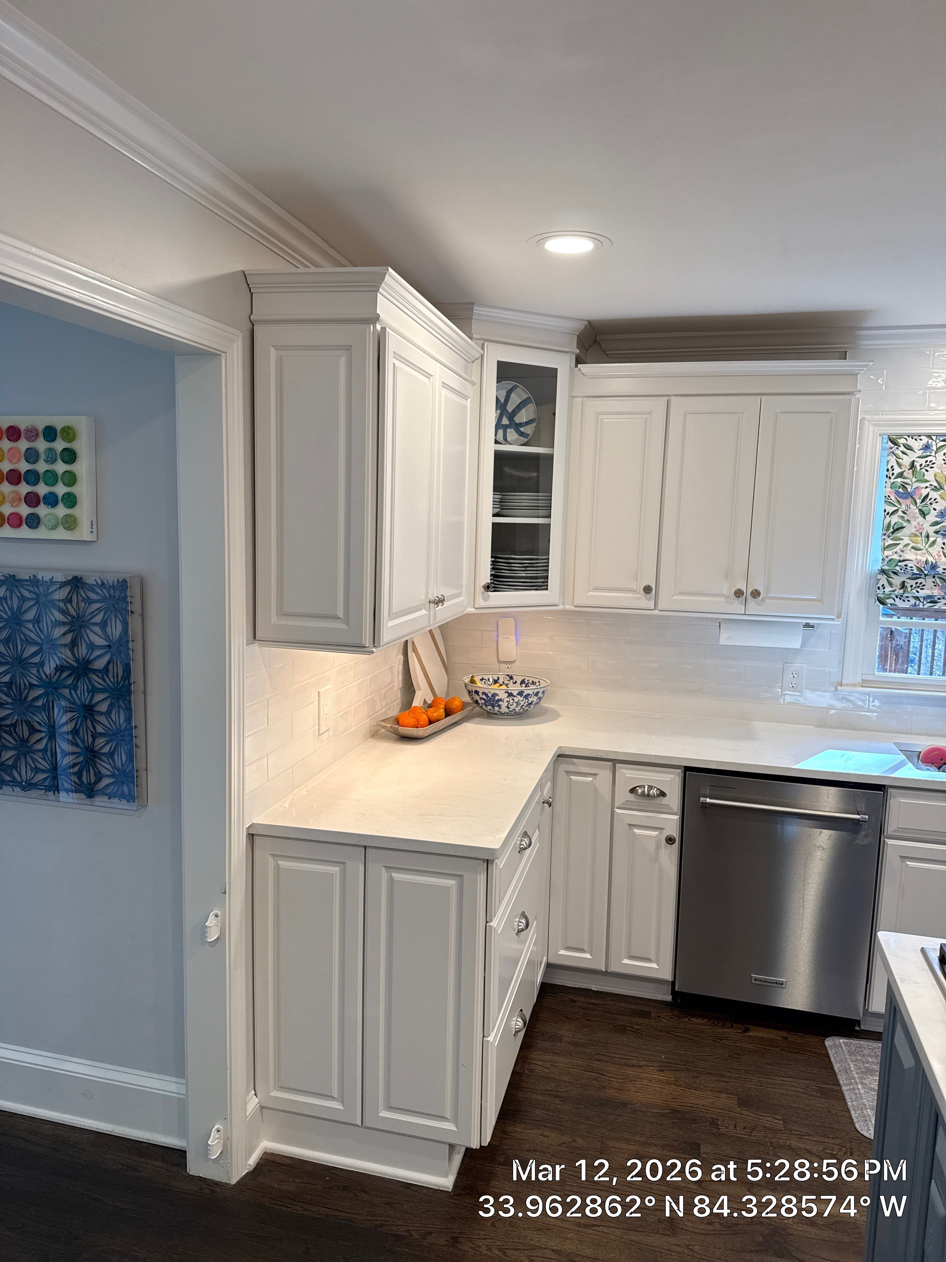 Kitchen Remodel in Dunwoody Featuring White Cabinetry and Blue Island by Heart & Home Kitchen & Bath Remodeling LLC