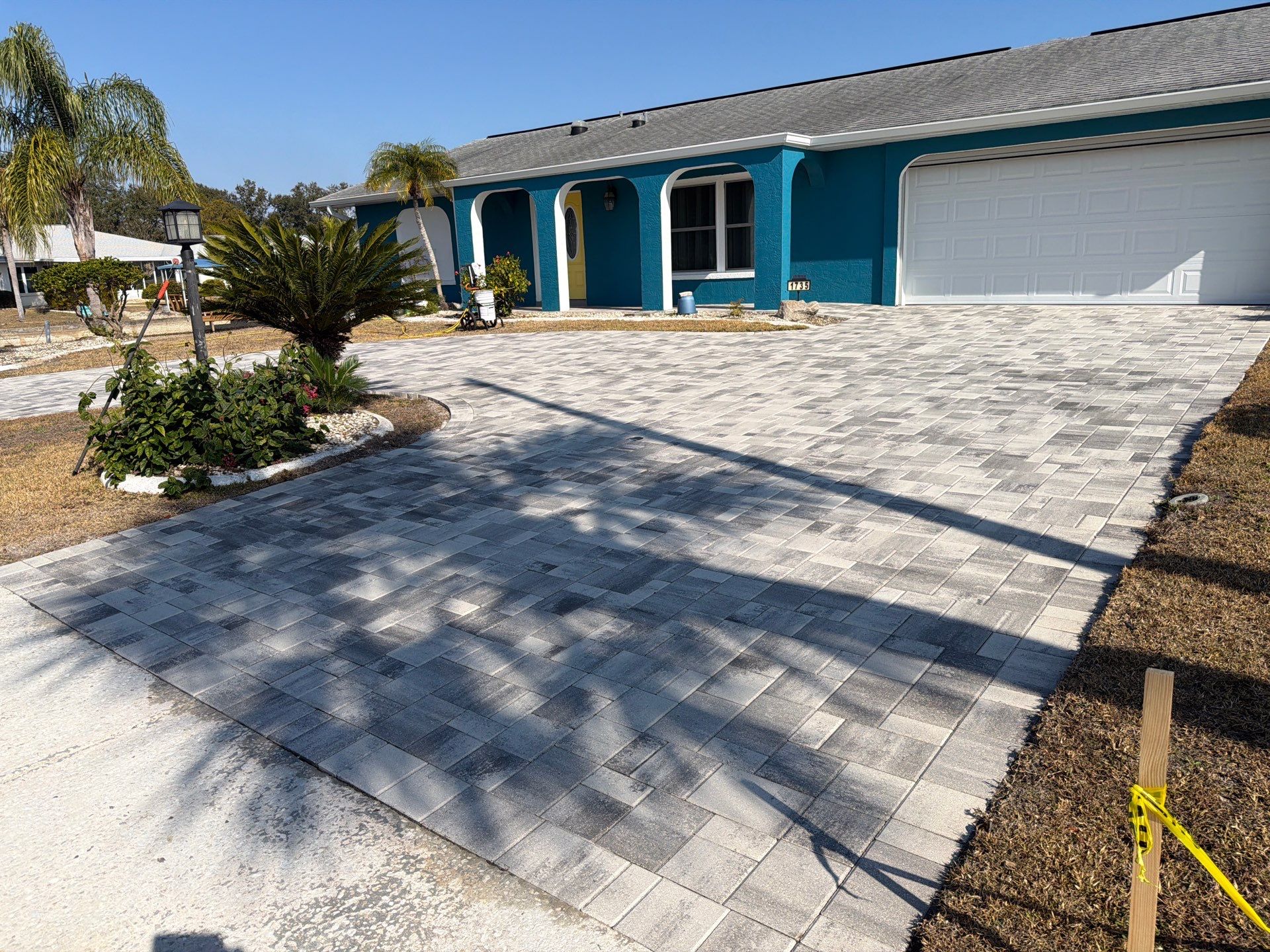 Modern Gray Paver Driveway and Entryway Walkway in Sun City Center by Supreme Paver Experts
