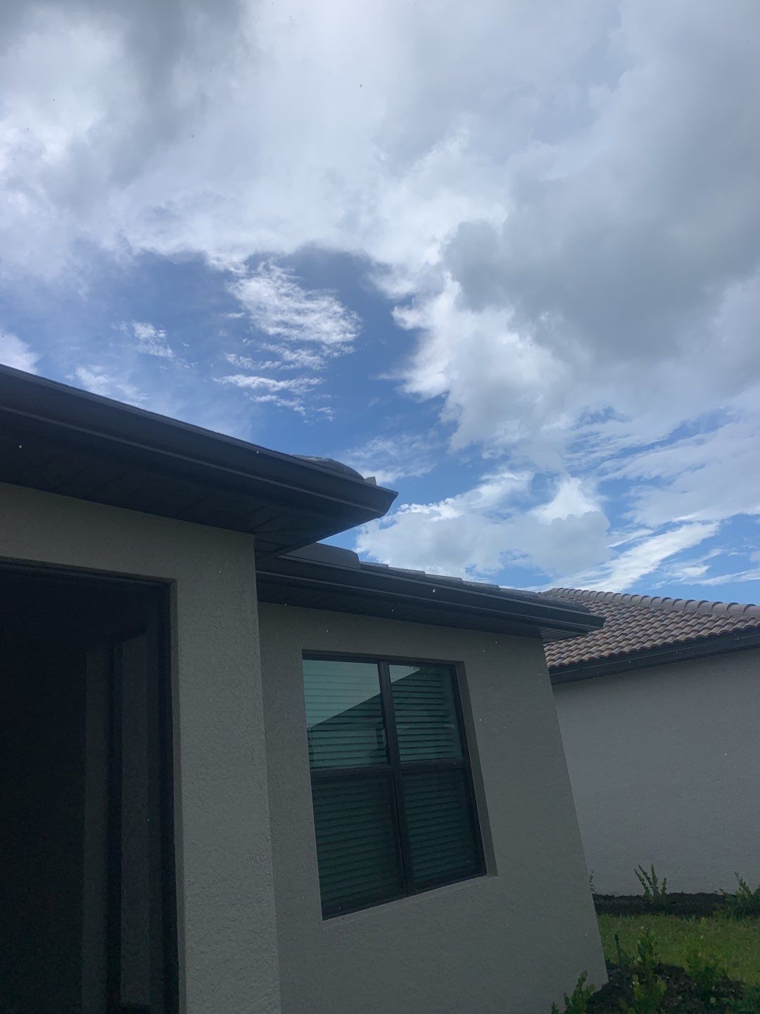 Seamless brown gutter and downspouts installation in Estero, FL  by Gutter Professors