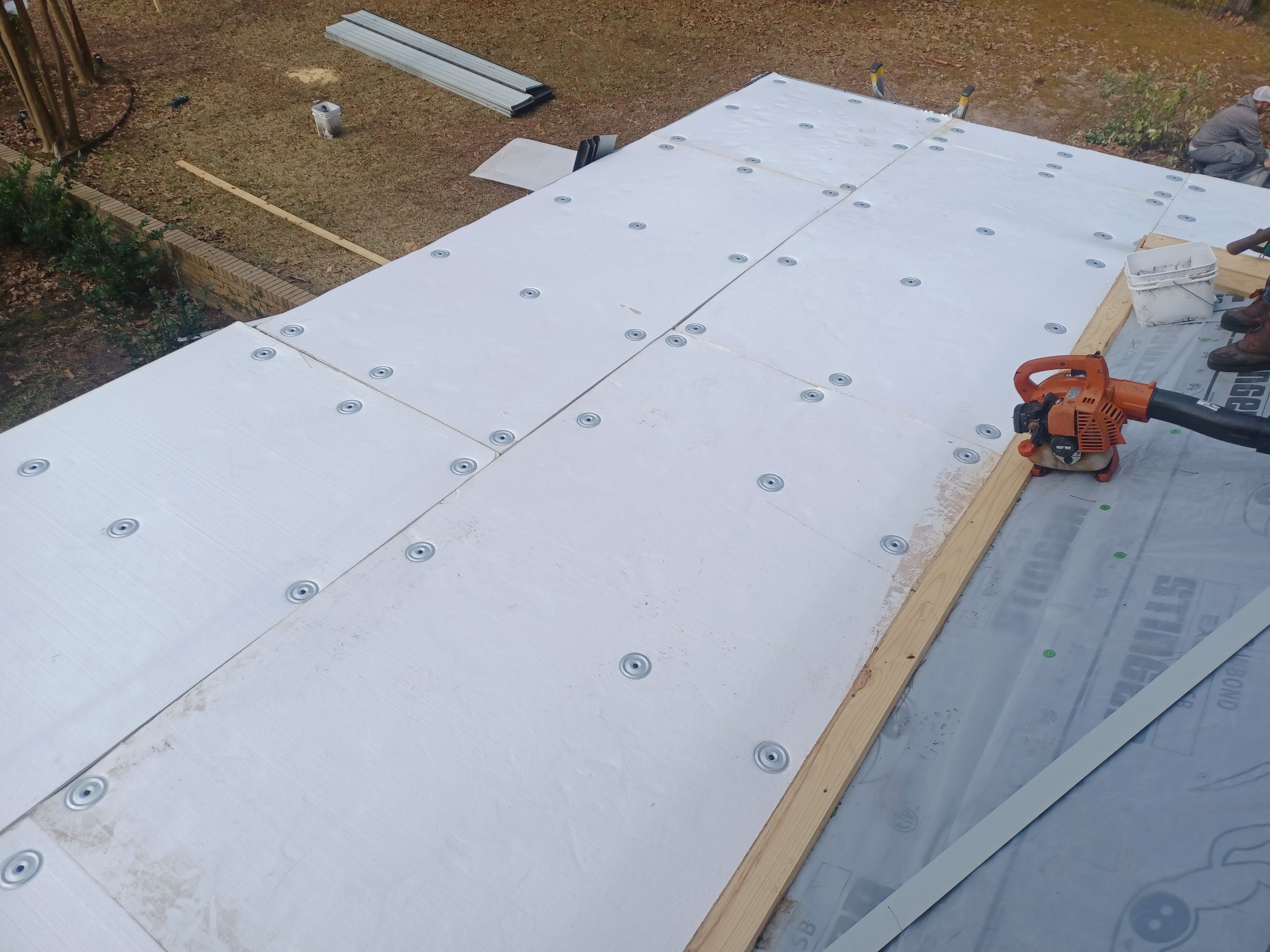 Residential Roofing Installation using PVC membrane and 24 gauge Standing Seam Metal by Hostetler Roofing
