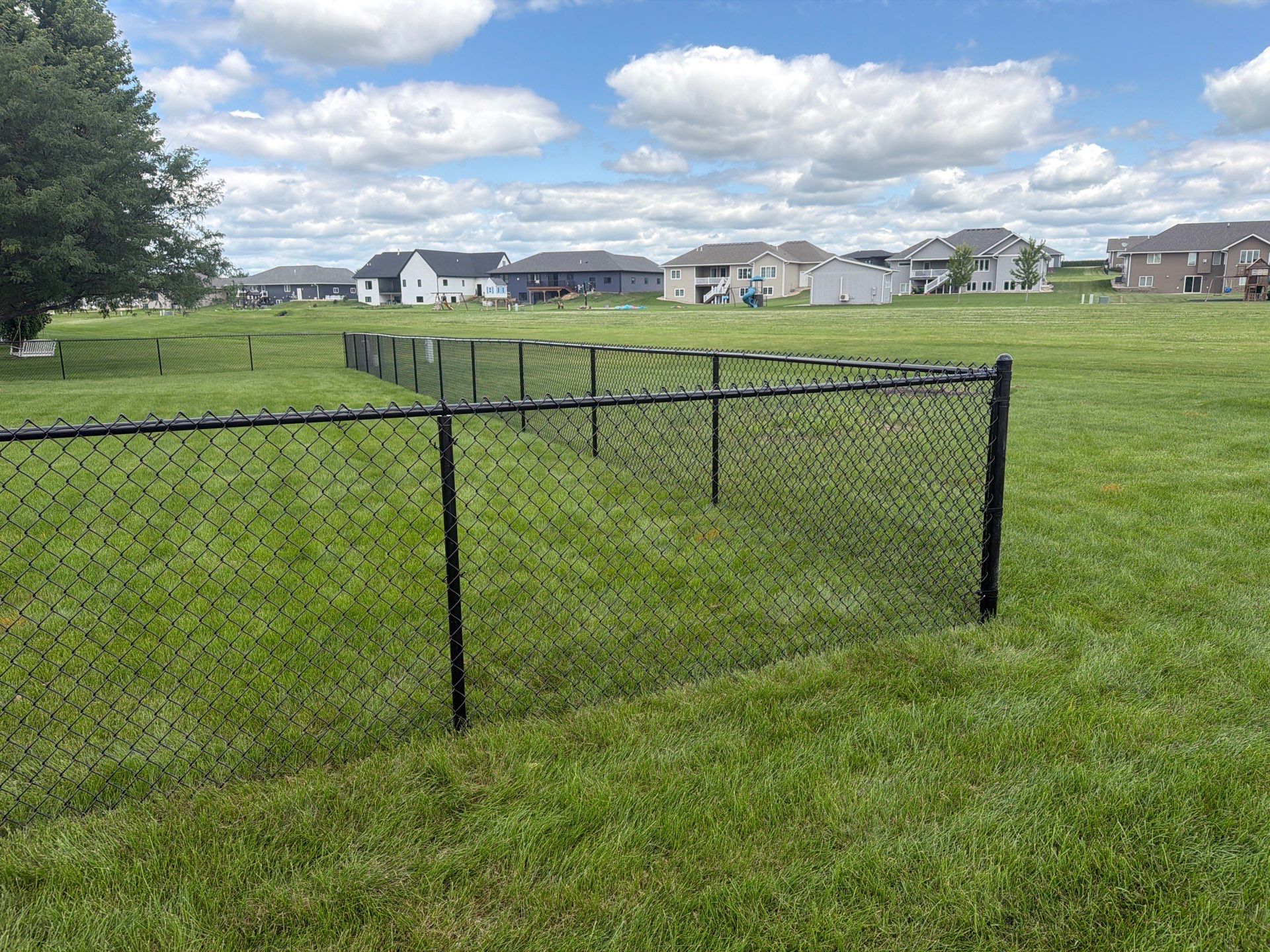Black Vinyl-Coated Chain Link Fence Installation in Fairbank by Perfect Picket Fence and Stain