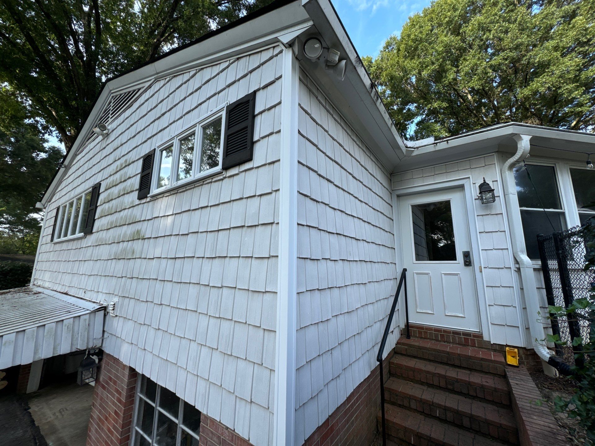 pressure washing of exterior siding and entrance steps to remove dirt and grime for a clean and refreshed appearance