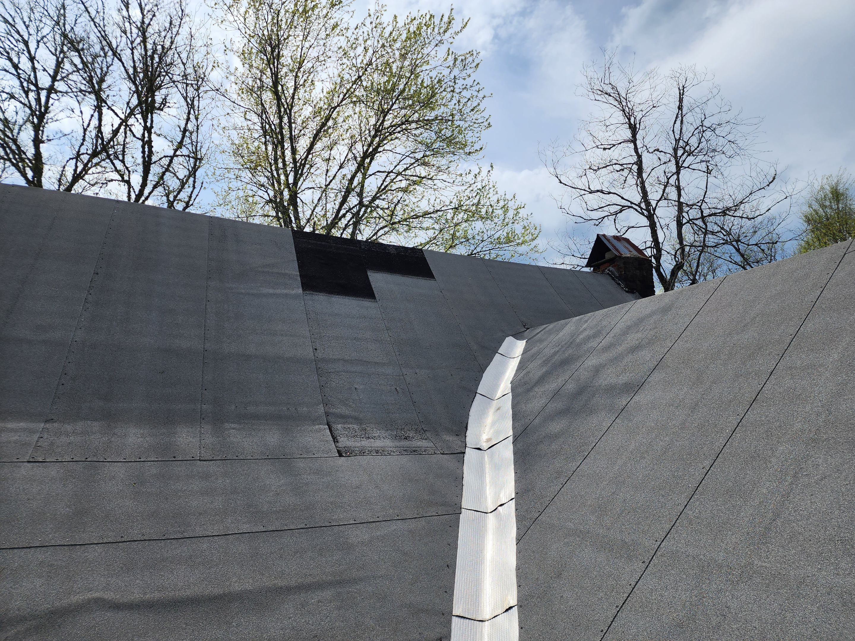 Residential Roofing Installation using 26 Gauge Colored Panels by Hostetler Roofing