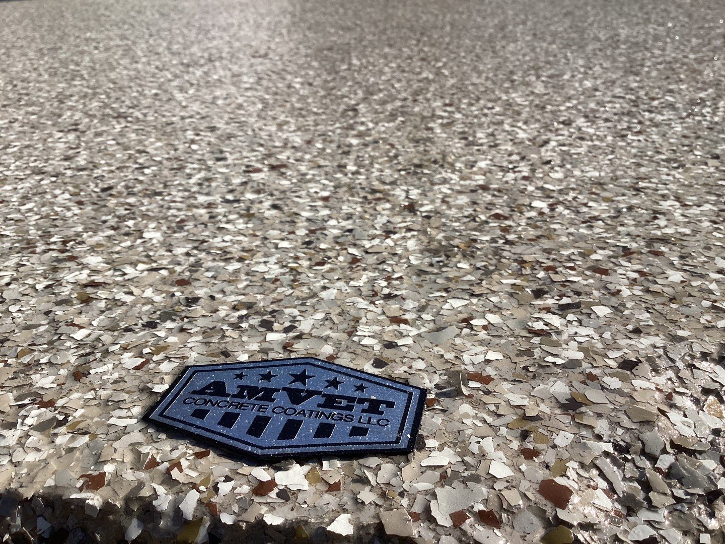 Driveway using Pebble Beach by Amvet concrete coatings llc