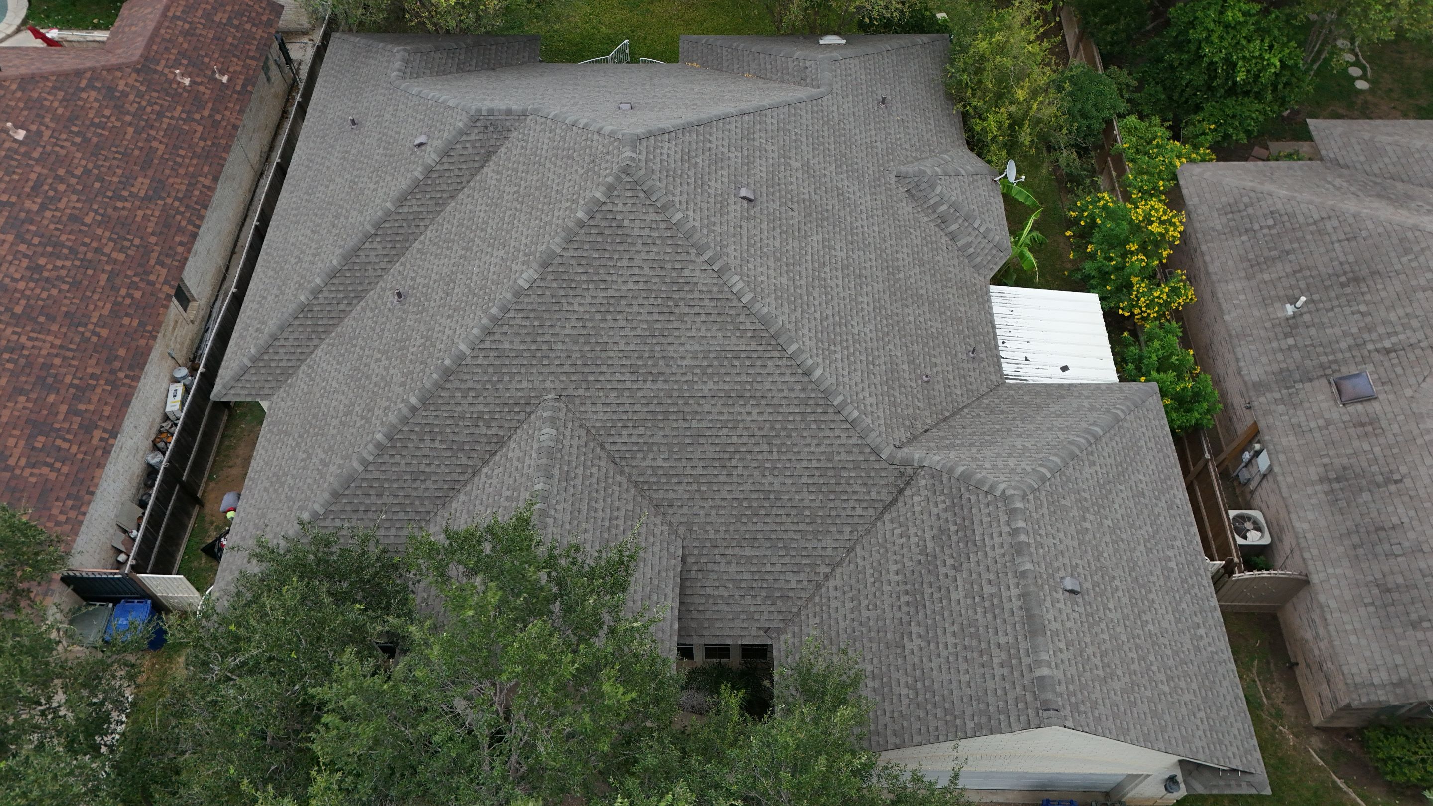 Residential Roof Replacement with Gray Composite Asphalt Shingles in Laredo by JM Flores Roofing & Construction, Inc
