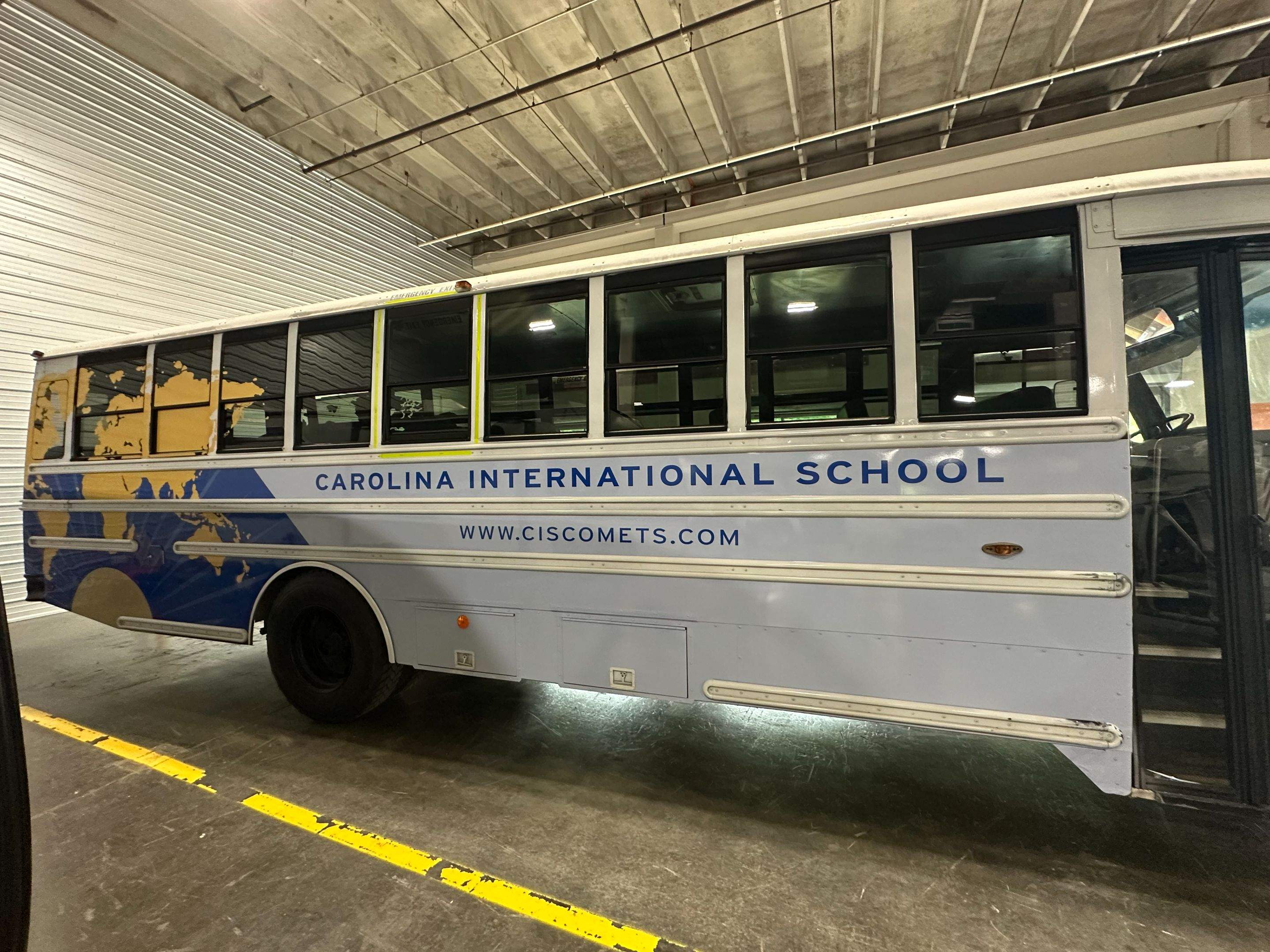 Carolina International School - Bus Vinyl Wrap by QC Signs and Graphics