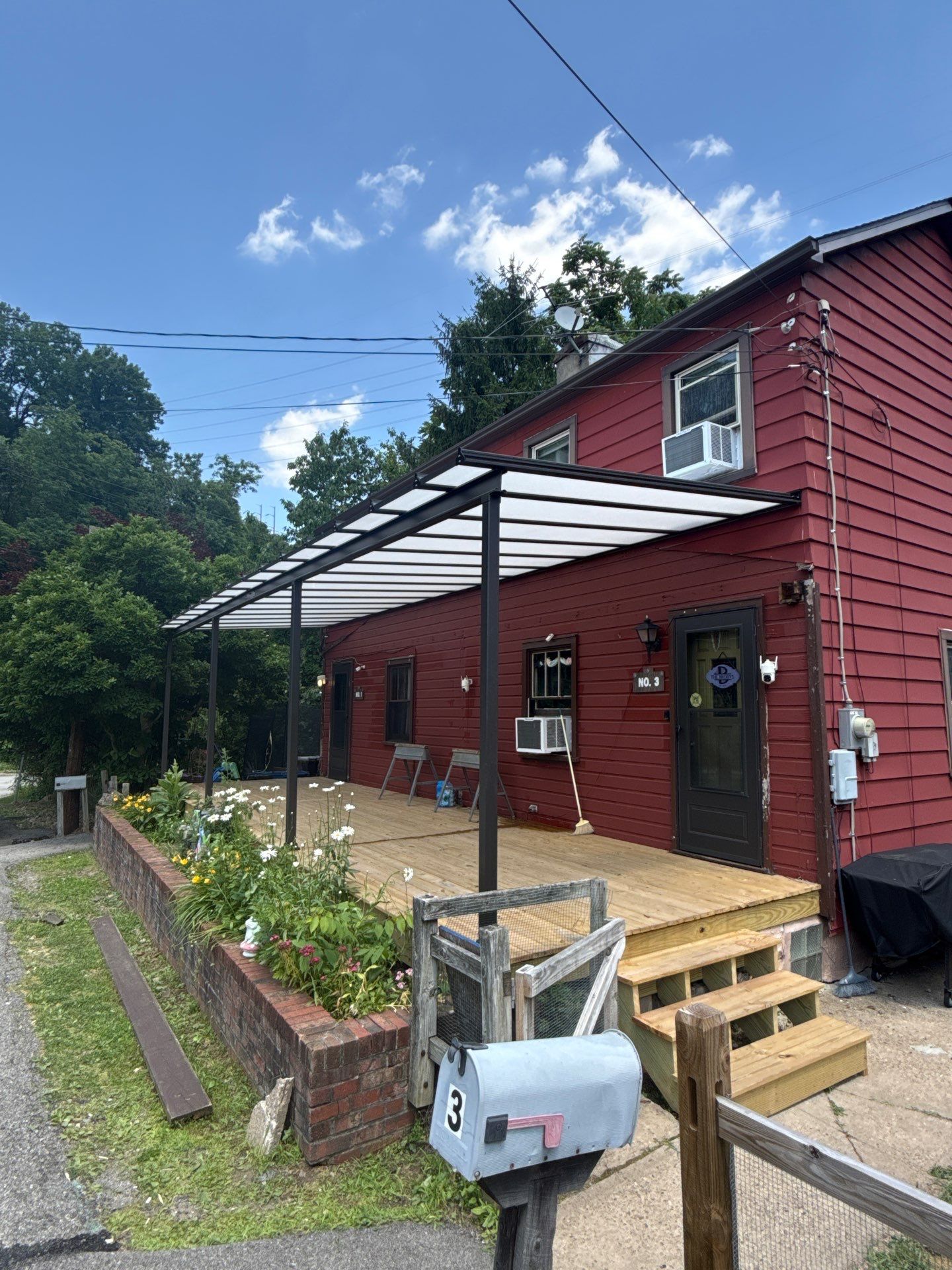 Roof sunspace deck  by Cousins Roofing Siding & Decks