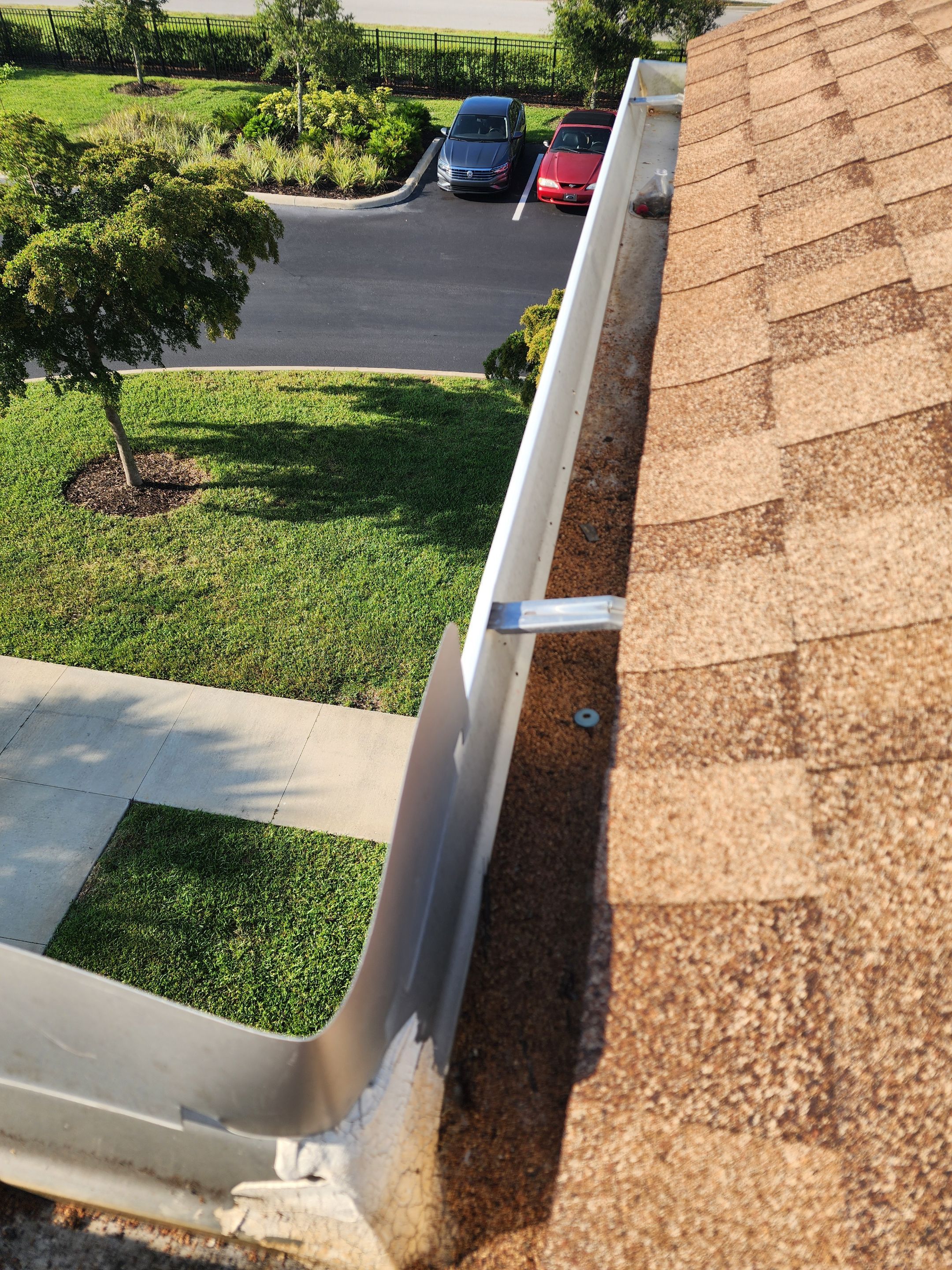 HOA gutter cleaning in Port Charlotte, FL before photo showing full gutters.