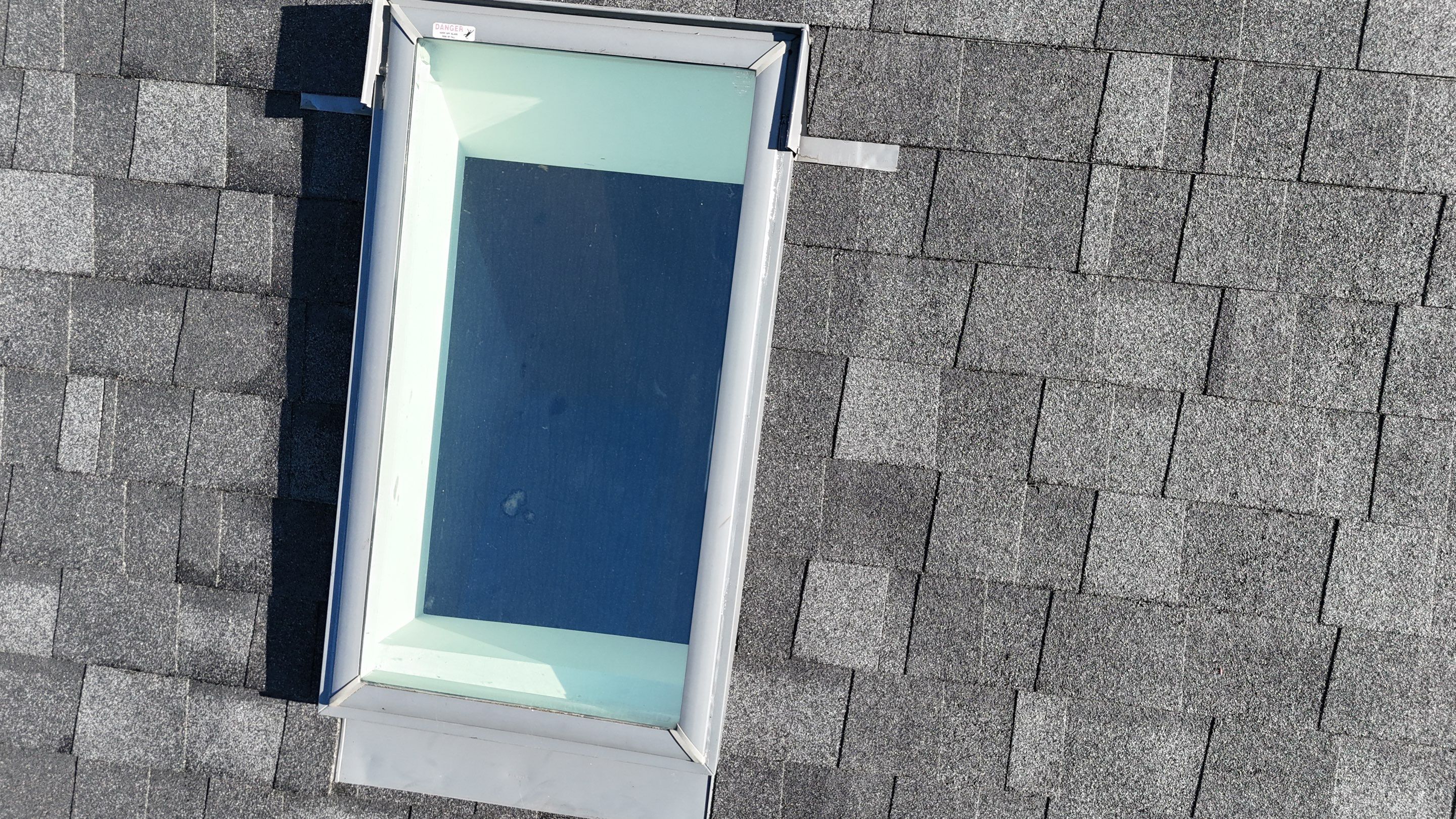 Roof Replacement with Skylight Flashing in Waltham, MA by Mighty Dog Roofing of Greater Middlesex County