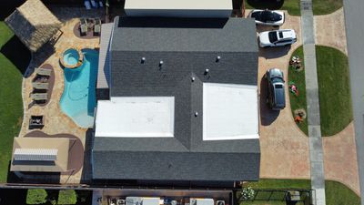 Residential Roofing Installation using Shingle reroof on slope and TPO single ply on flat roof.