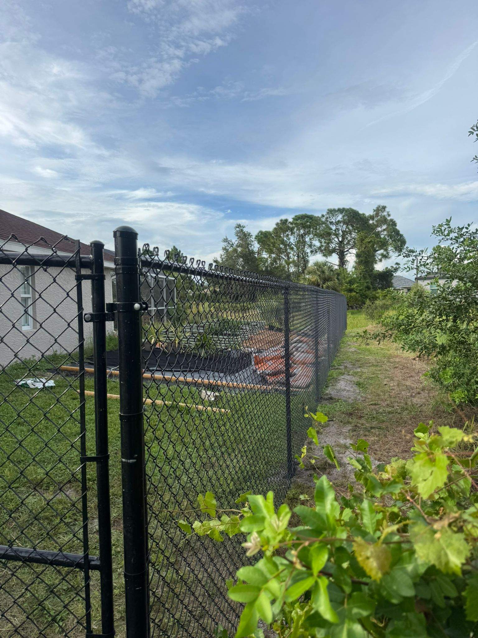 Black Vinyl-Coated Chain Link Fence and Gate Installation in North Port by True Fence LLC