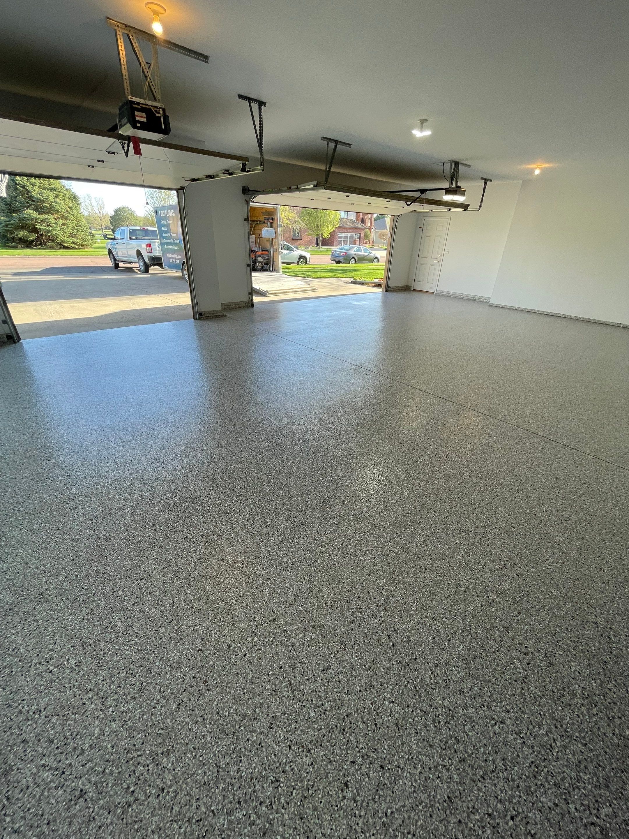 Yankton Garage Floor Restoration with Gray Speckled Epoxy Coating by Select Painting, Coatings & Garage Cabinets