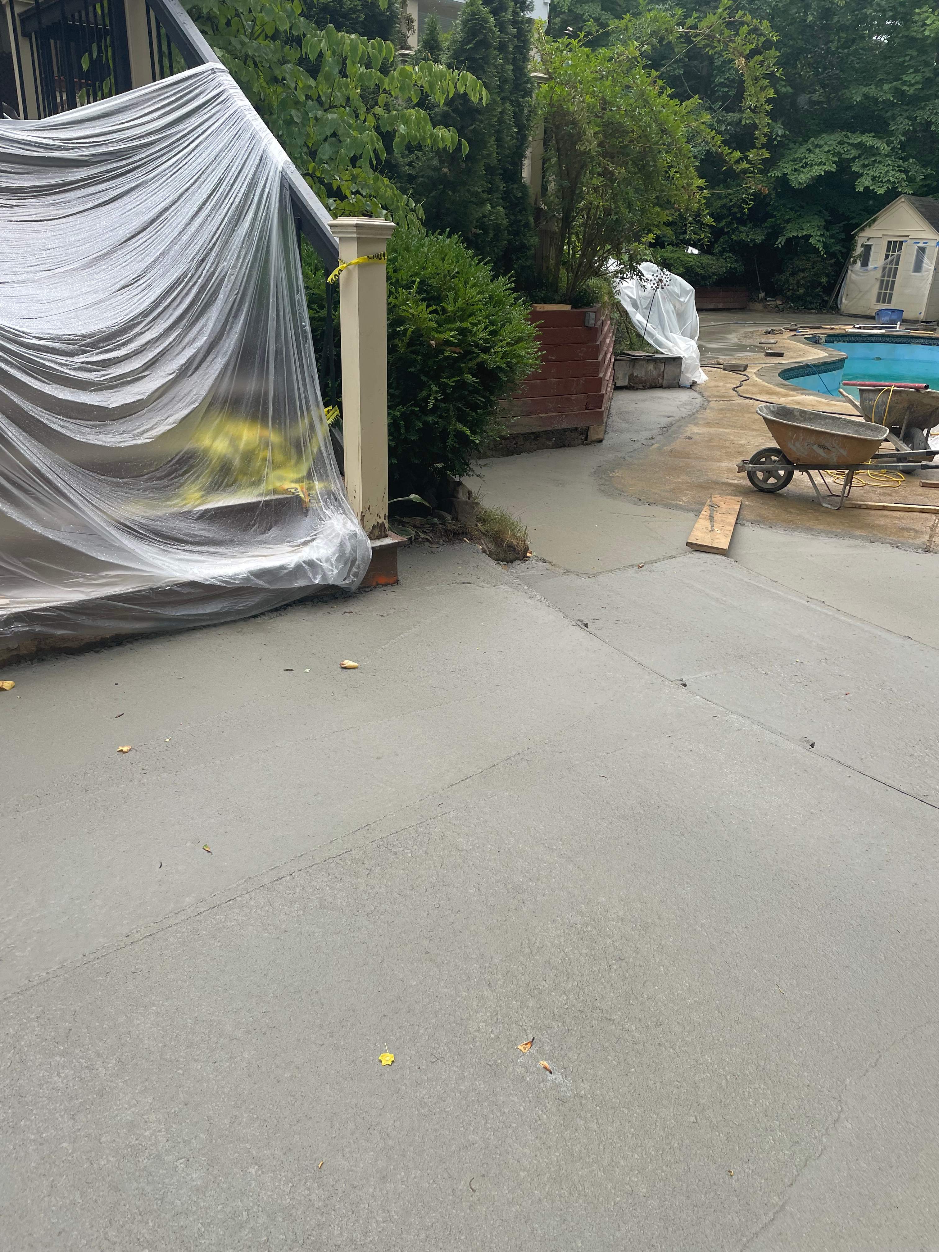Pool Surround remodel with retaining walls, new waterfall and water slide by Fairfax Contractors, LLC