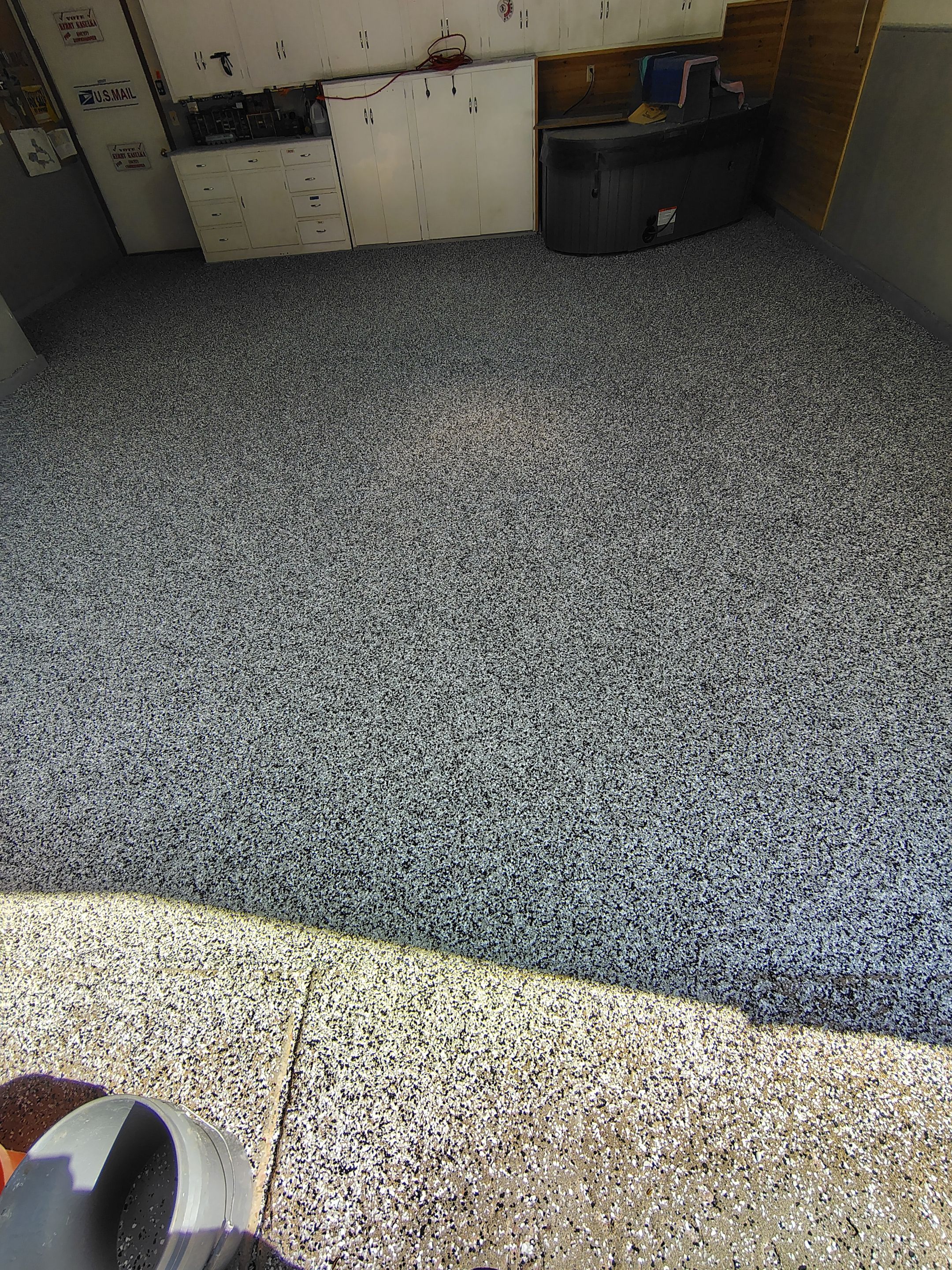 Domino Flake Garage Floor Coating Installation in Sioux Falls by Select Painting, Coatings & Garage Cabinets