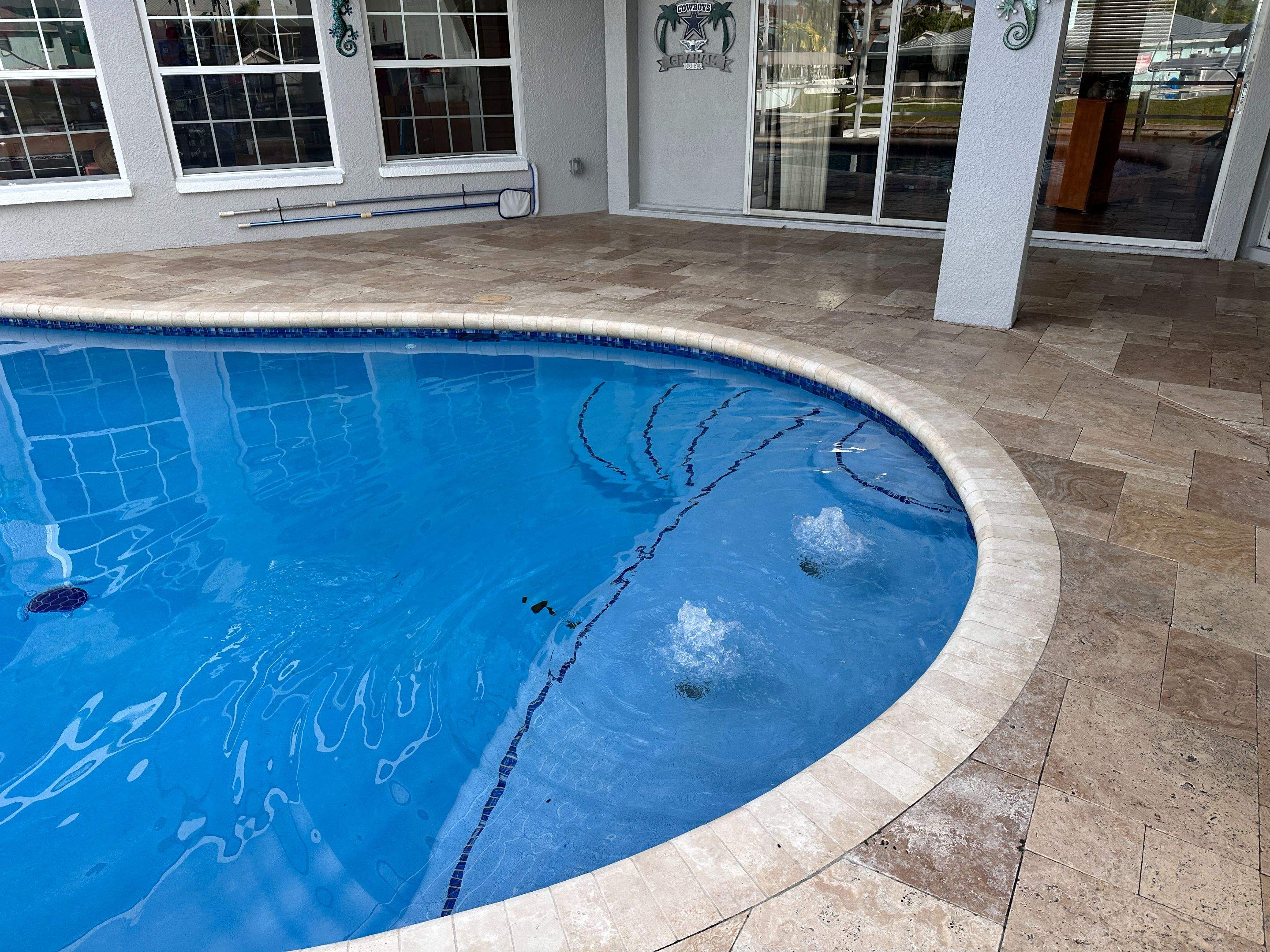 Travertine Sealing and Stripping for a Waterfront Pool Deck in Apollo Beach by Supreme Paver Experts