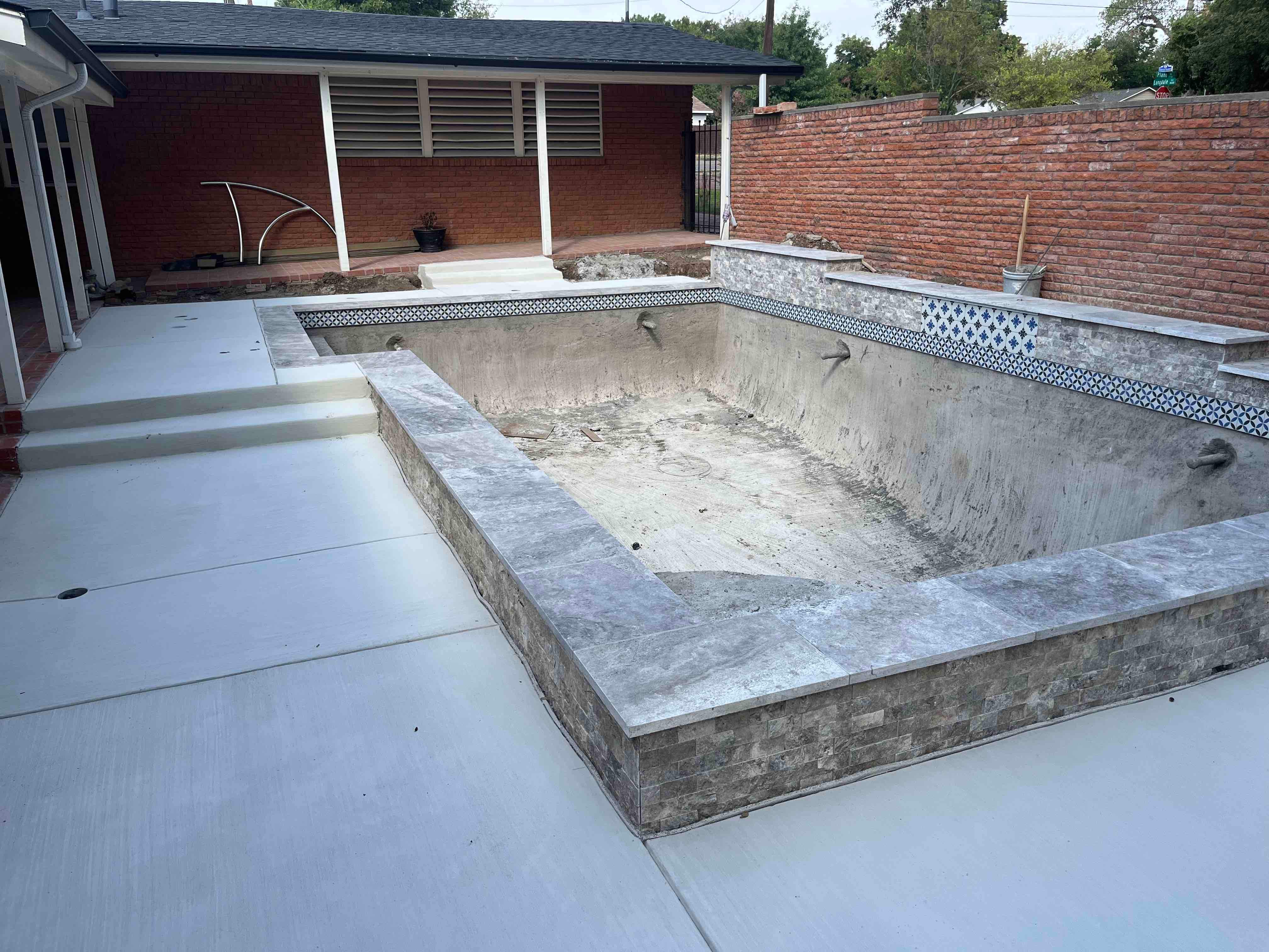Geometric Pool with Raised Stone Wall and Sheer Descent by Pinnacle Pools and Spas - DFW