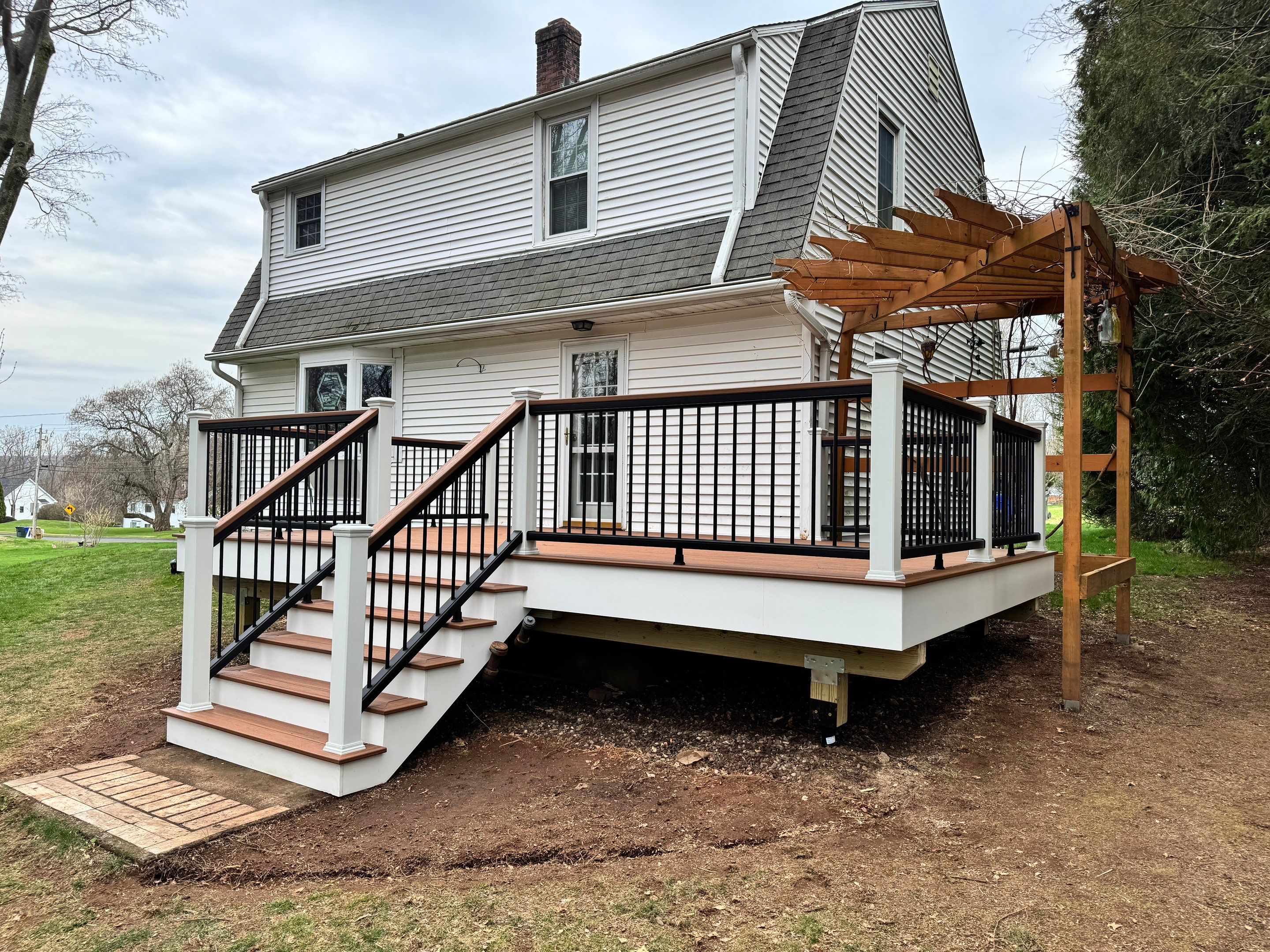 Replacement deck with Trex Transcend Tiki Torch deck boards and matching cocktail rail. by DiGiorgi Roofing and Siding Inc
