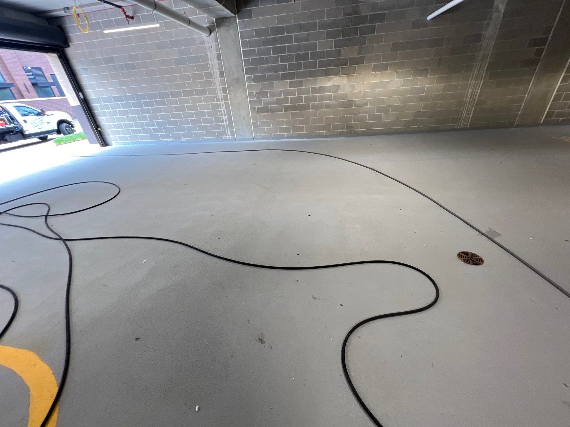 Parking garage using Hot water by Northern Power Washing LLC.