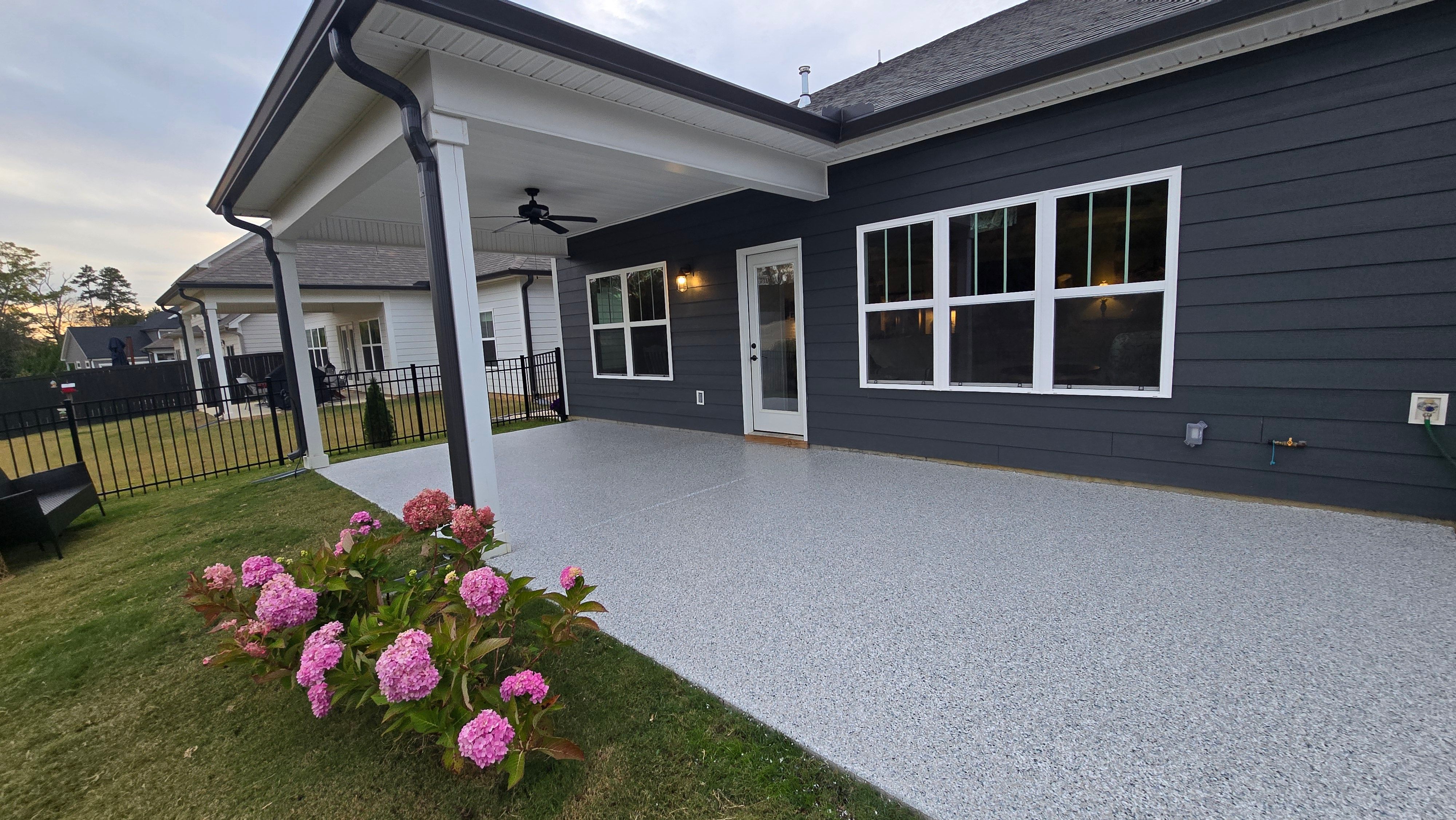 Sidewalk, Porch, and Back Patio Using Creekbed and Nordic Green by Elite Floor Solutions