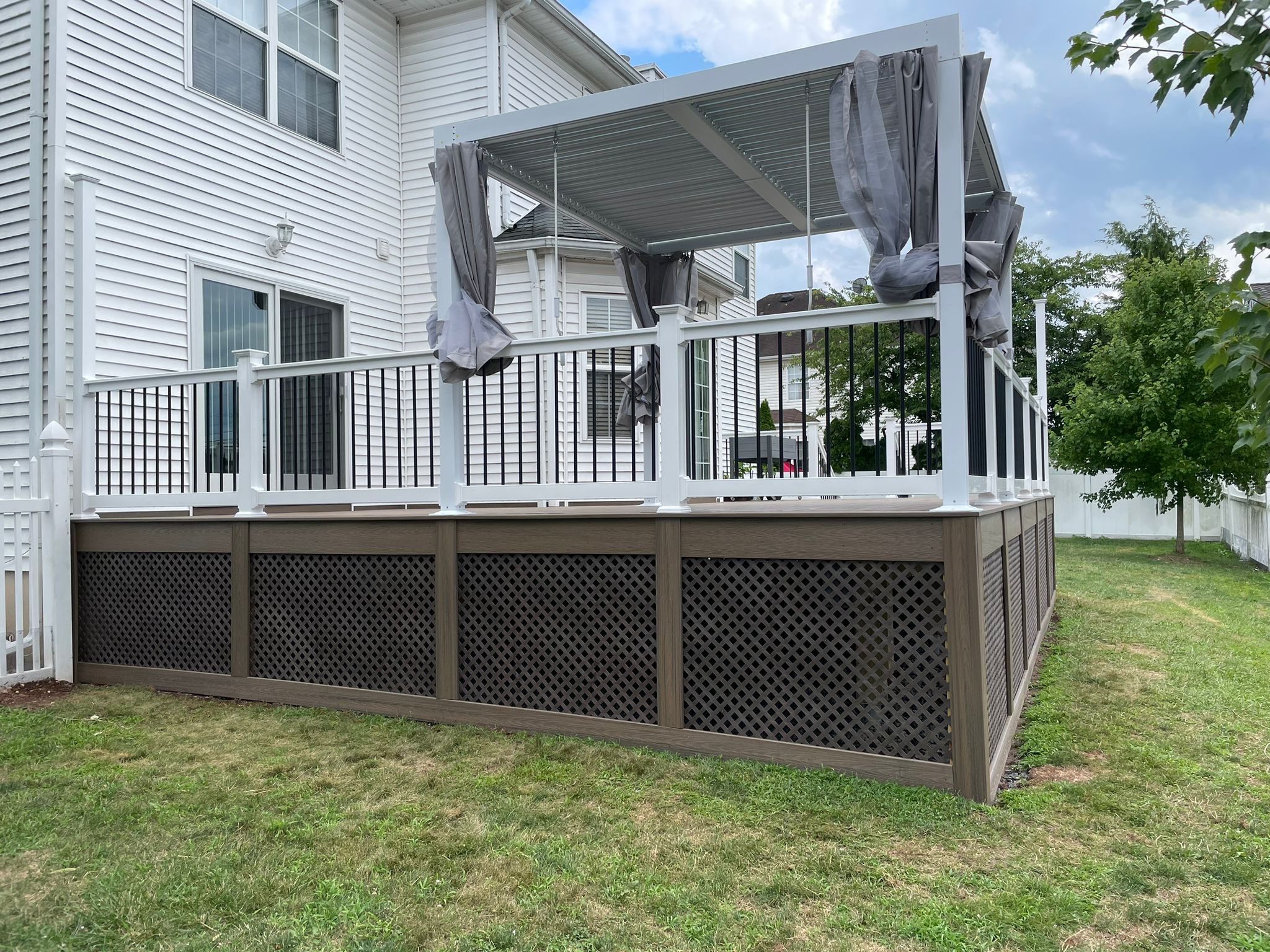New Deck with Pergola and Vinyl Lattice by deck guardian