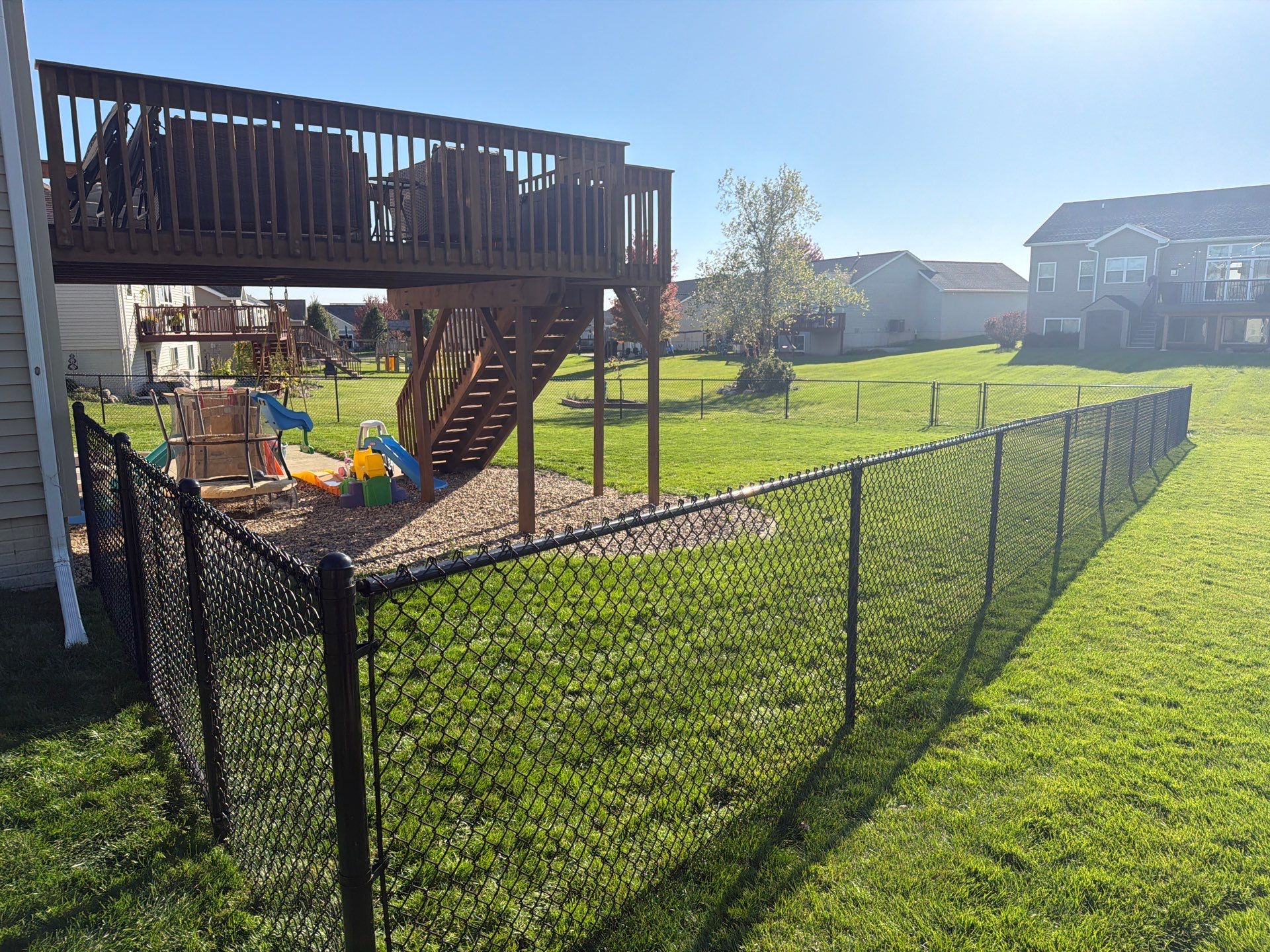 Black Vinyl-Coated Chain Link Fence Installation in Cedar Falls by Perfect Picket Fence and Stain