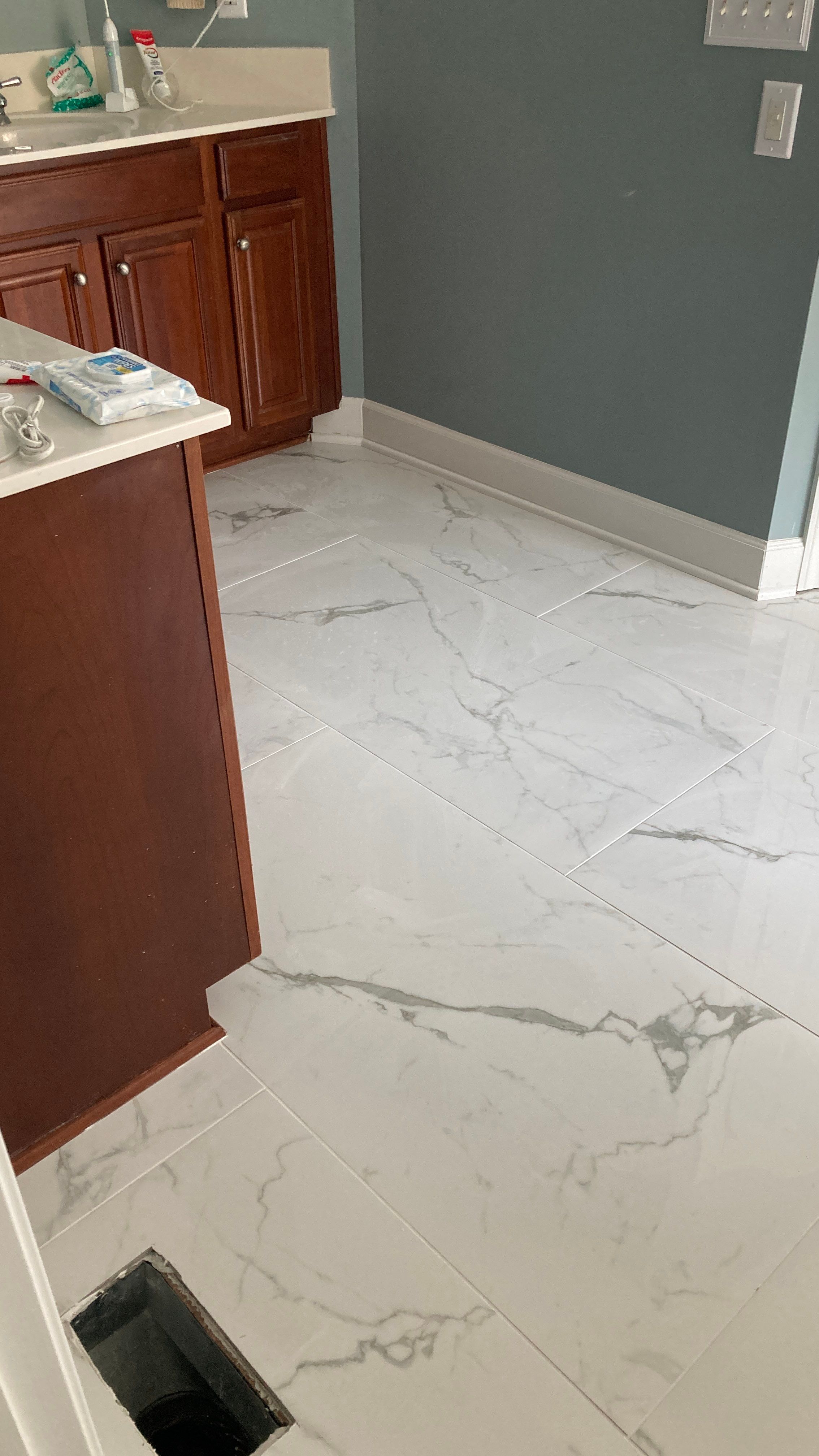 Lovely marbled bathroom floor  by Footprints Floors of Nashville