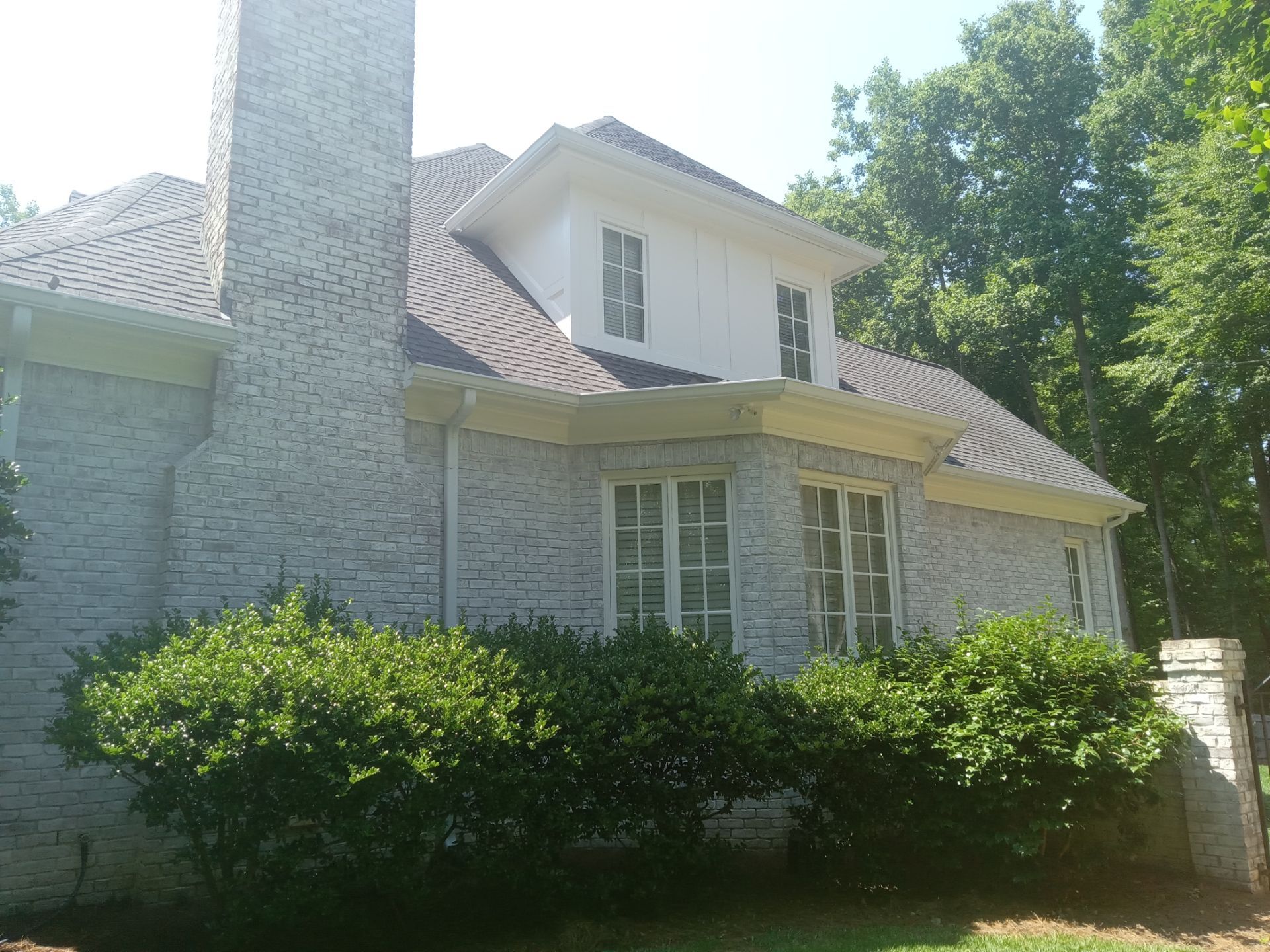 pressure washing exterior house surfaces including brickwork siding trim windows to remove dirt and stains