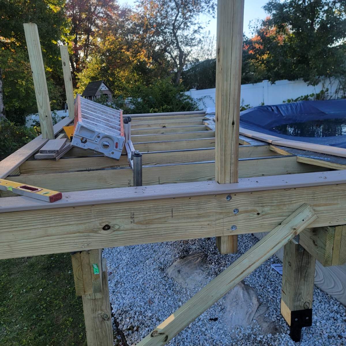 New pool deck and main deck resurface using Trex Transcend Rope Swing boards, White railing and Lattice by DiGiorgi Roofing and Siding Inc