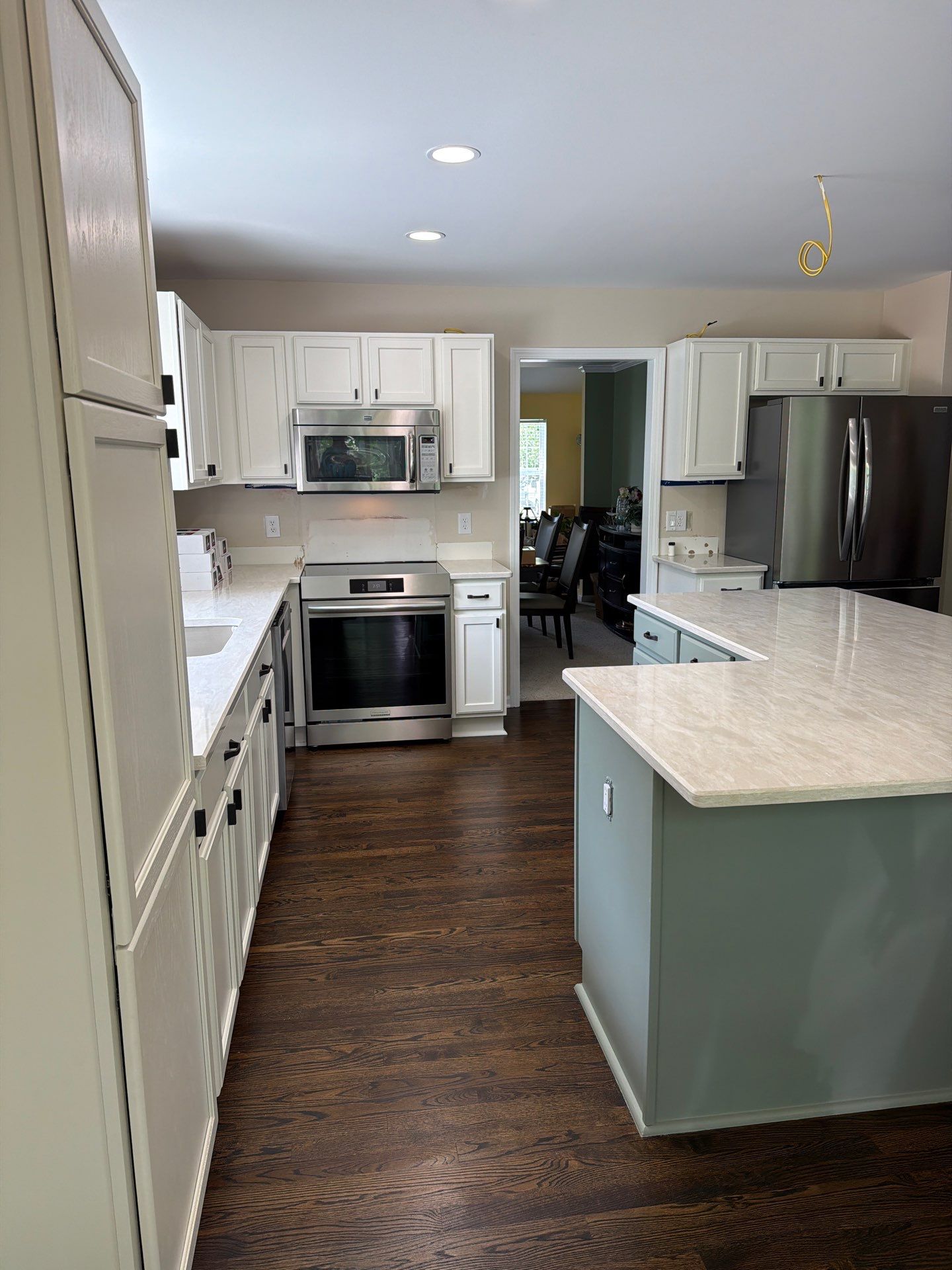 Two-Tone Kitchen Cabinet Refinishing in Sage Green and White by Top Shelf Painter
