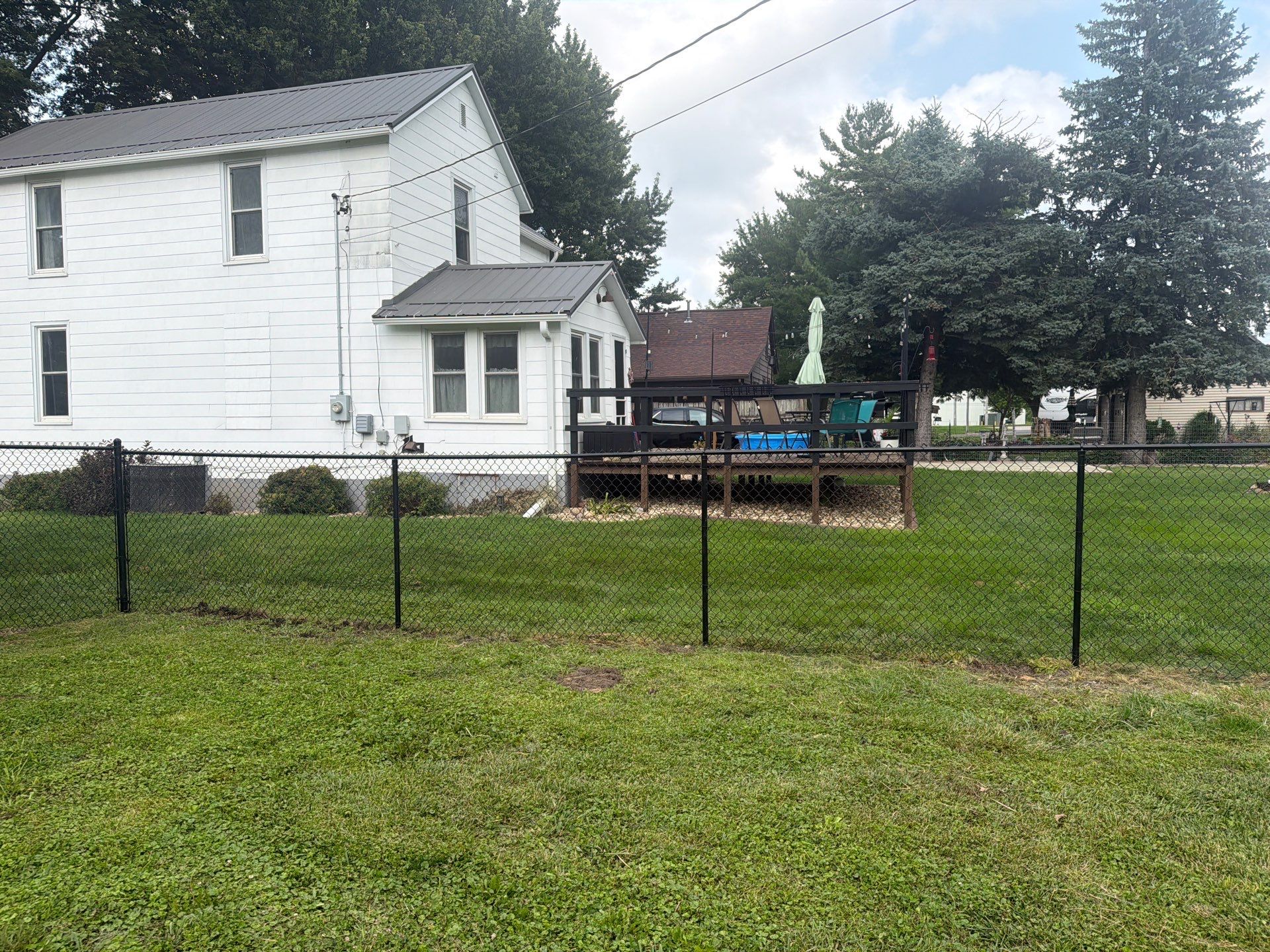 Residential Black Chain Link Fence Installation in Reinbeck by Perfect Picket Fence and Stain