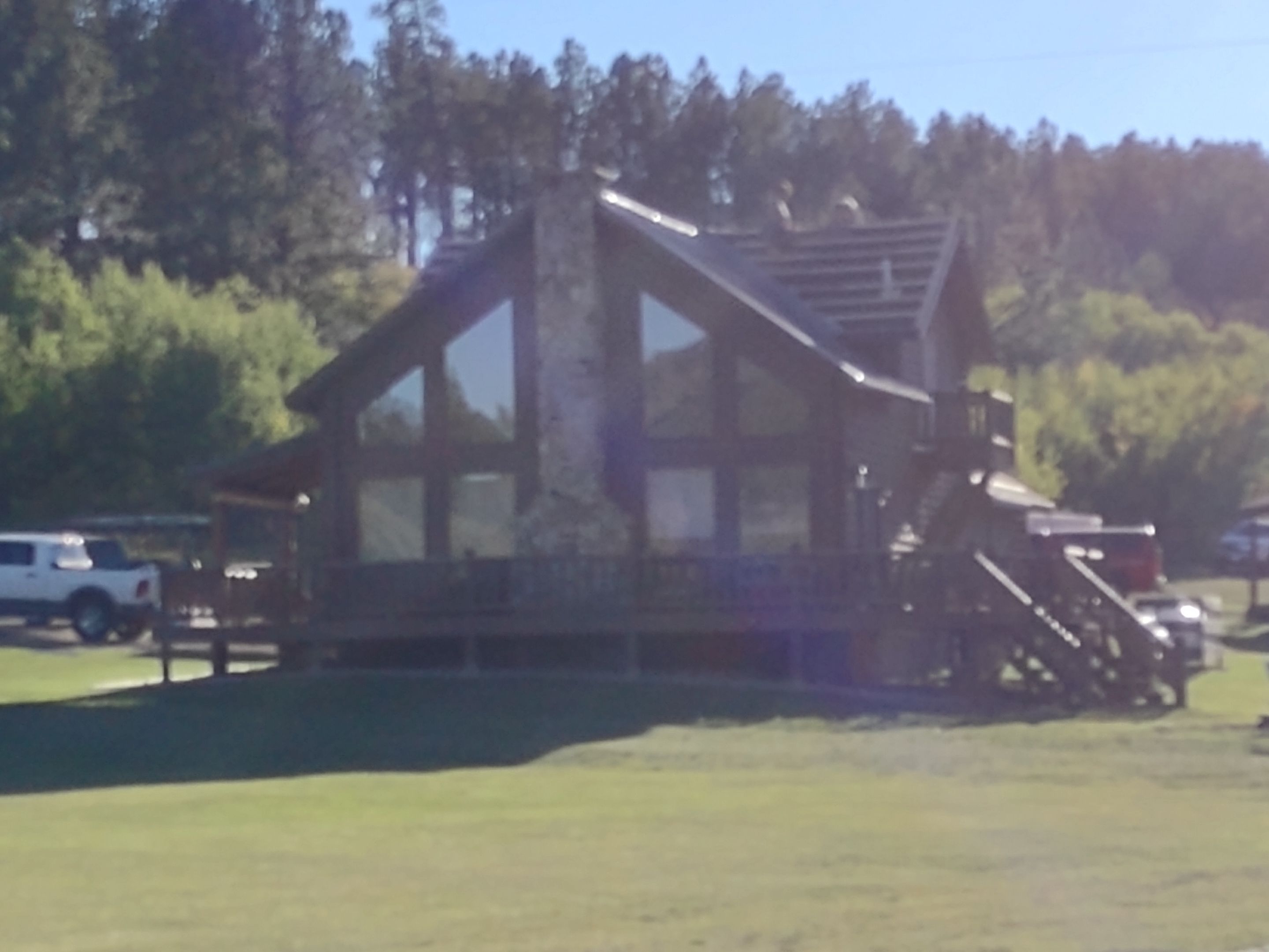 Hill Country Guest Ranch using Steel Roofing, Gutters, Log Cabin Staining by Lightning Exteriors