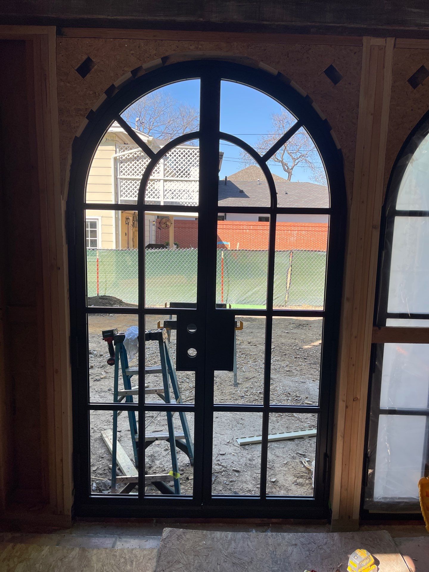 Arched Black Metal French Door Installation and Finishing in Fort Worth by Solara Custom Living