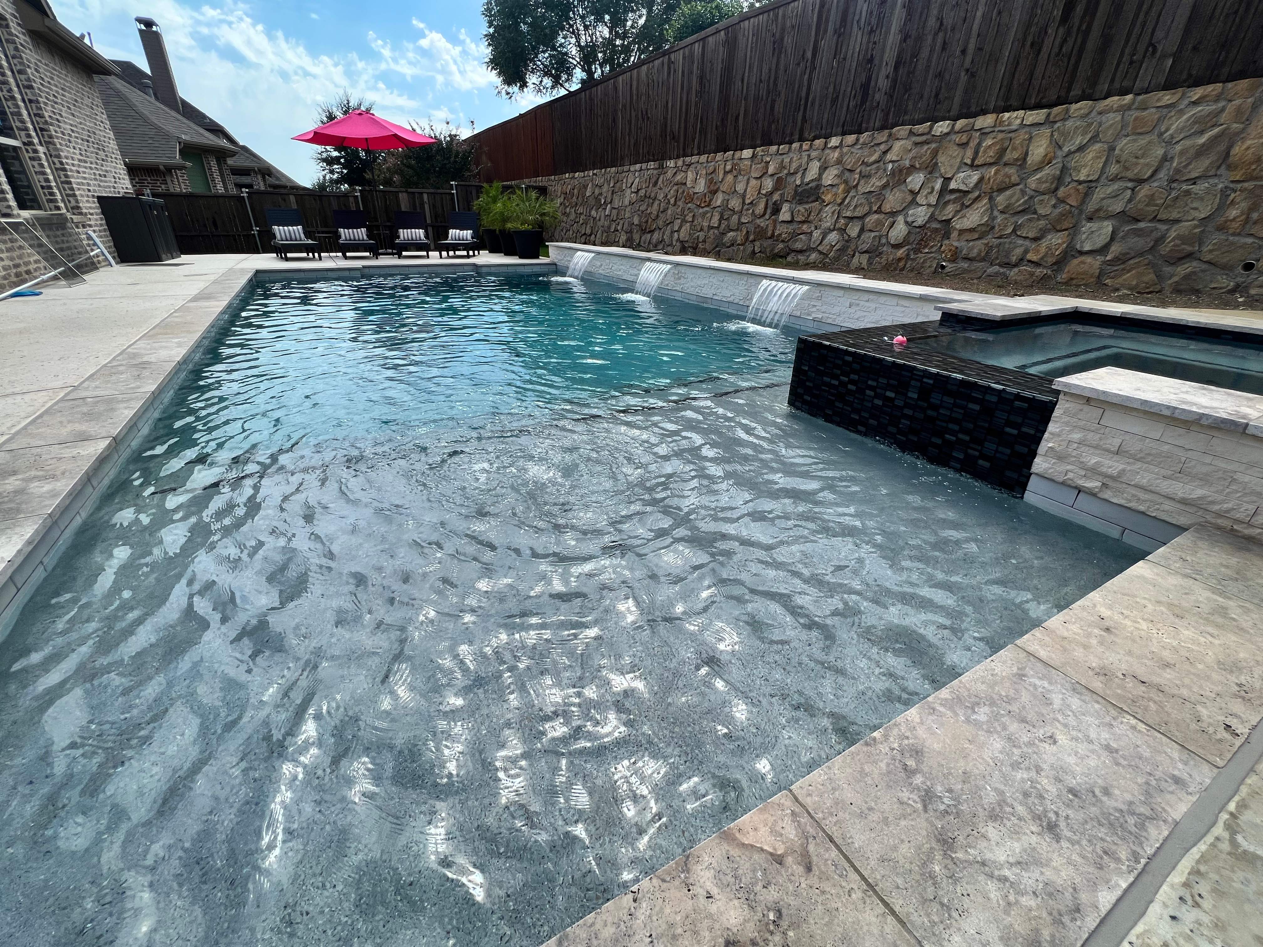 Geometric Pool with Raised Spa and Stone Decking by Pinnacle Pools and Spas - DFW