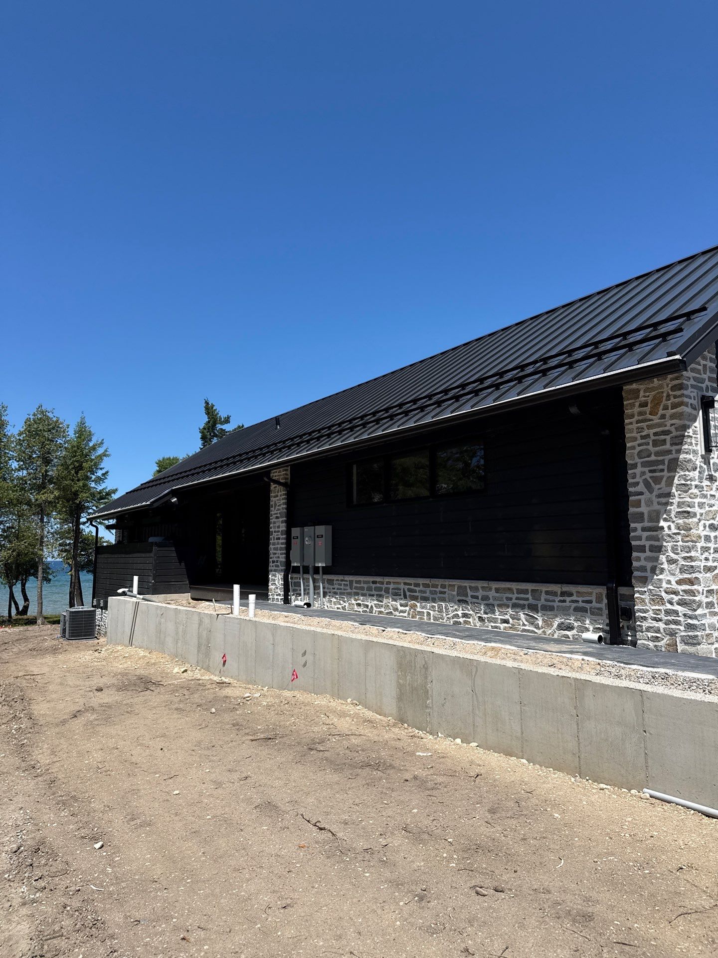 Gutter and Drainage System Installation for Modern Residential Build by Rainbow Seamless Systems