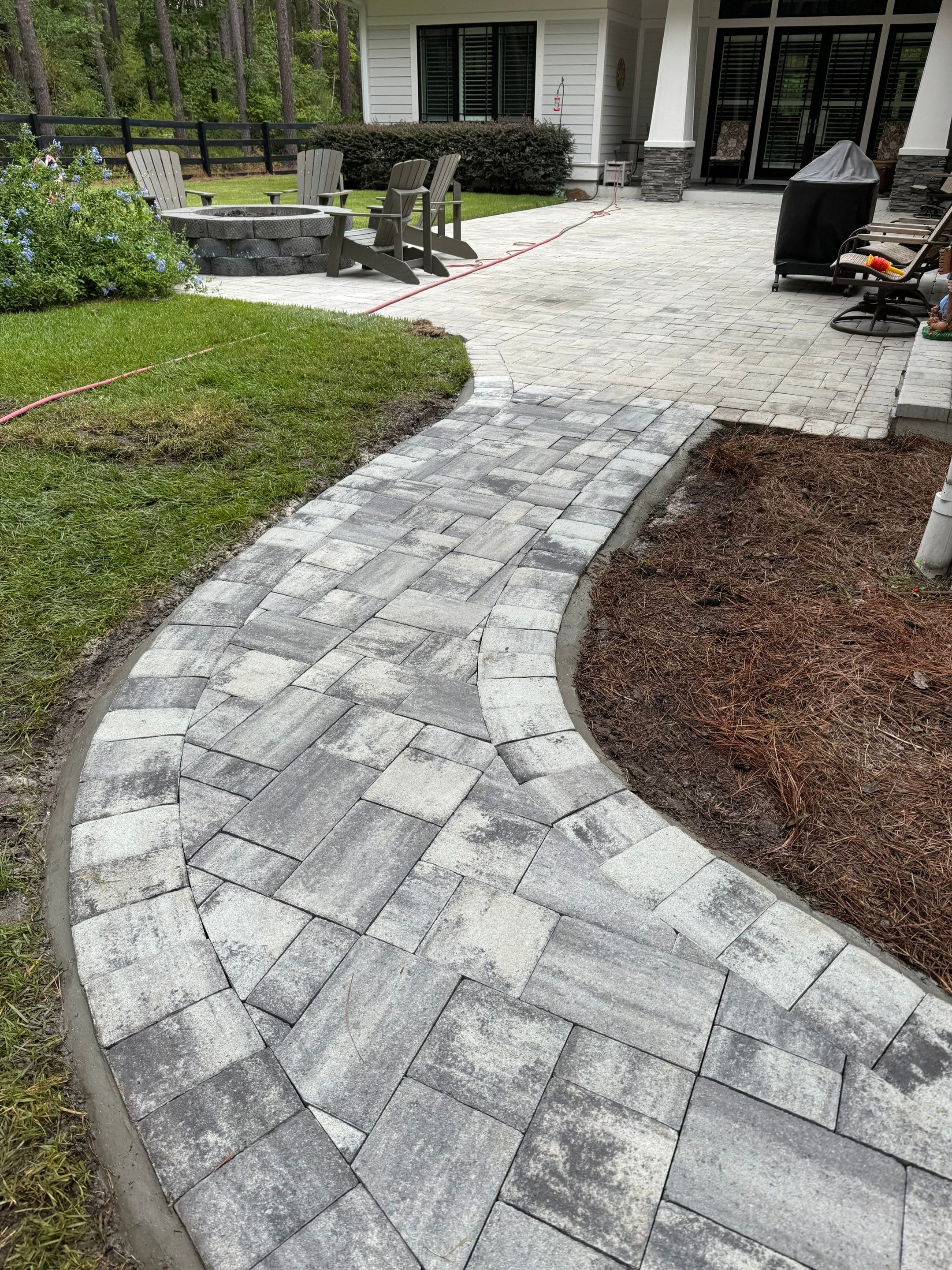 Curved Gray Paver Walkway Installation in Bluffton by Lowcountry Scapes, LLC
