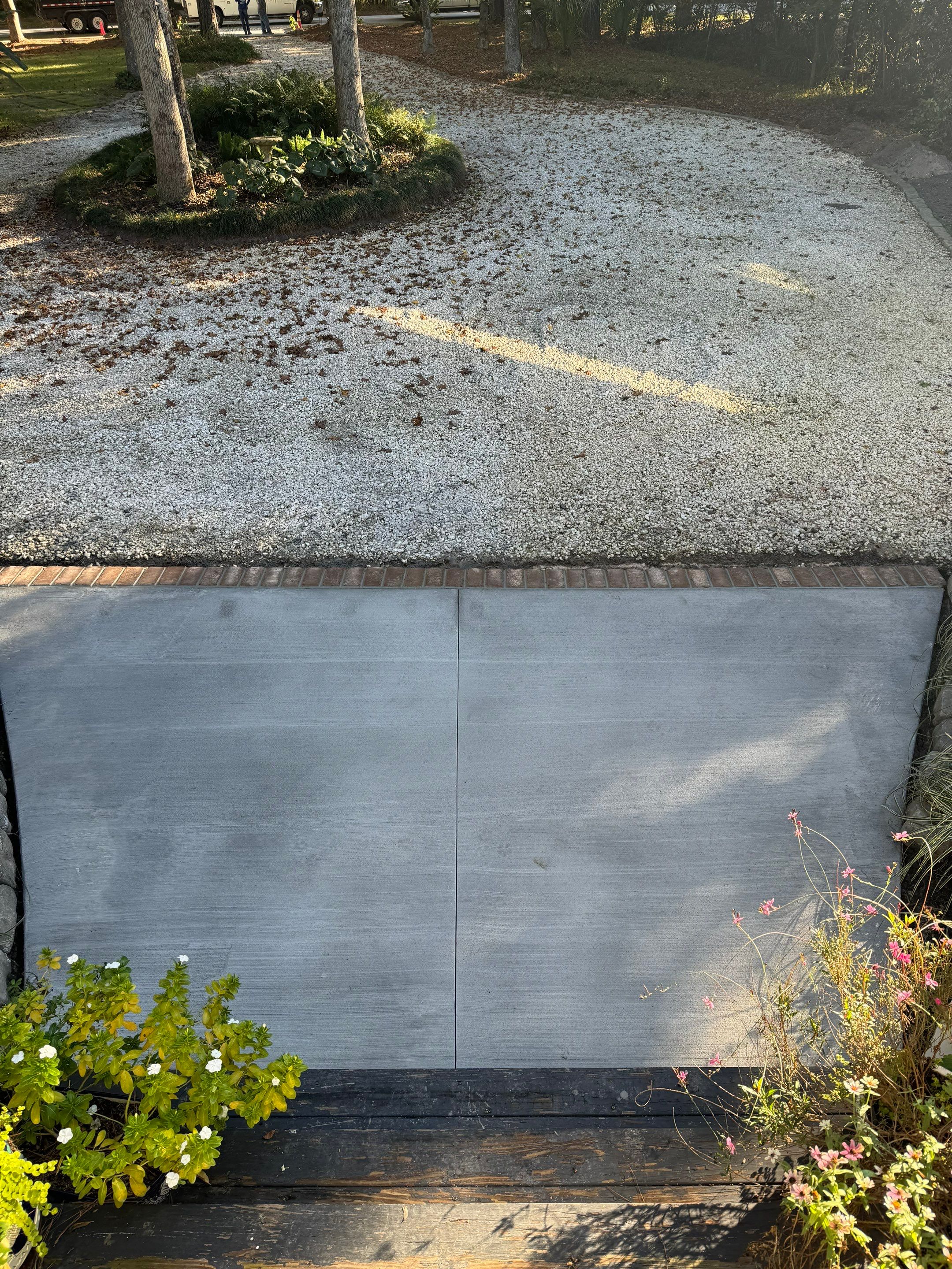 Concrete Driveway and Patio Installation With Decorative Brick Borders by Lowcountry Scapes, LLC