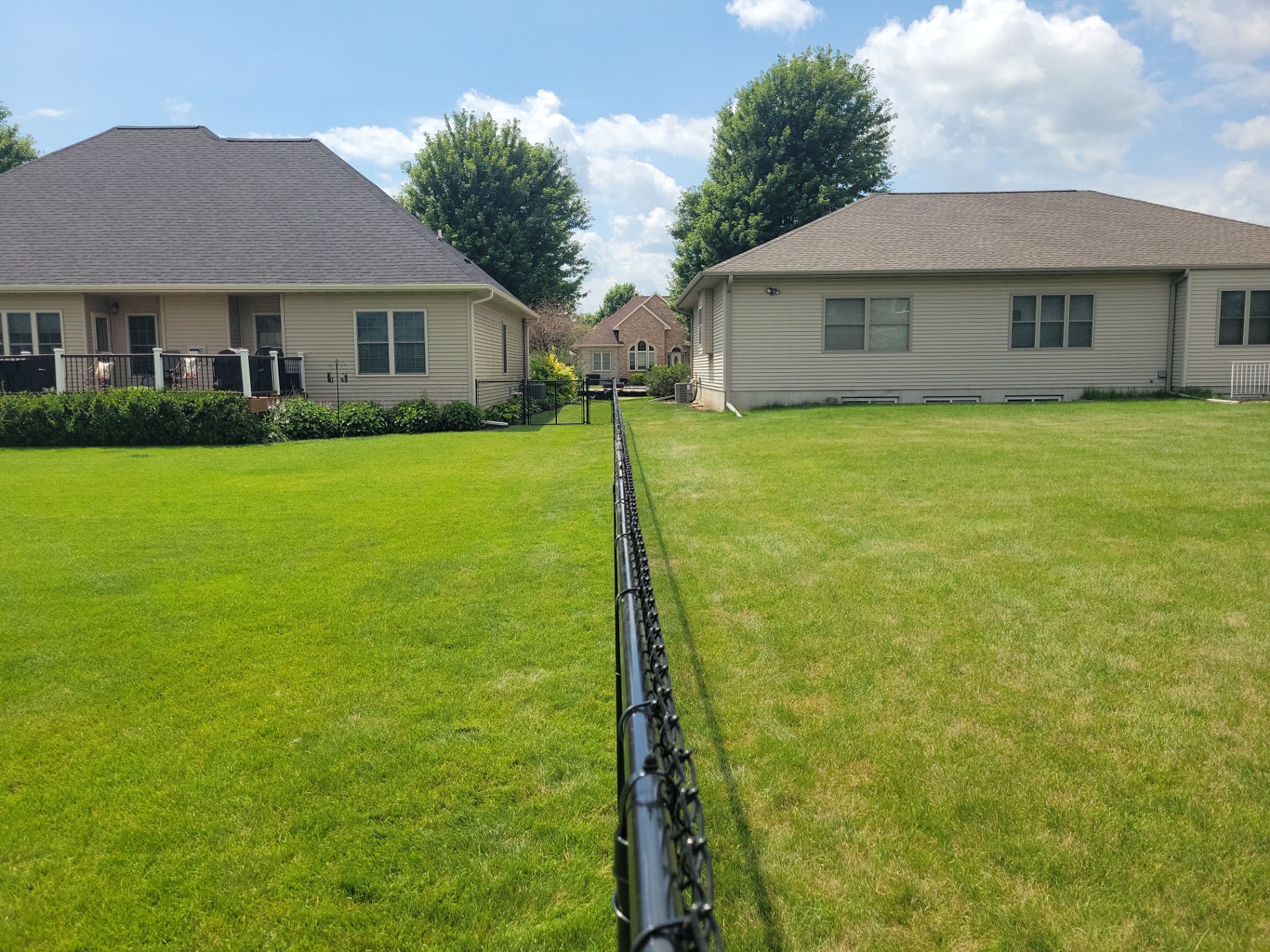 Black Vinyl Coated Chain Link Fence Installation in Cedar Falls by Perfect Picket Fence and Stain