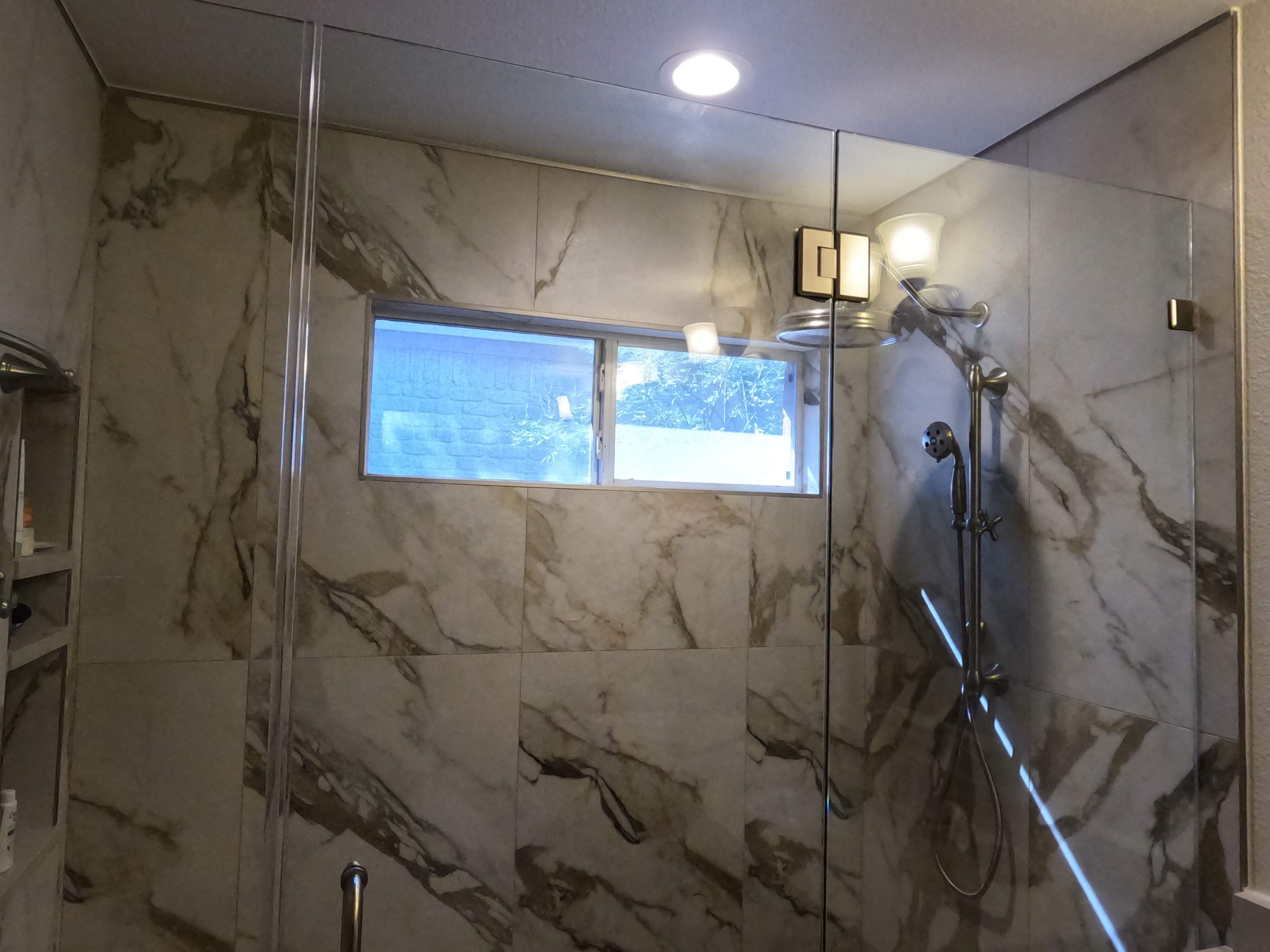 Master Bathroom Renovation Featuring Marble-Look Tile and Quartz Countertops by Mena stone surfaces