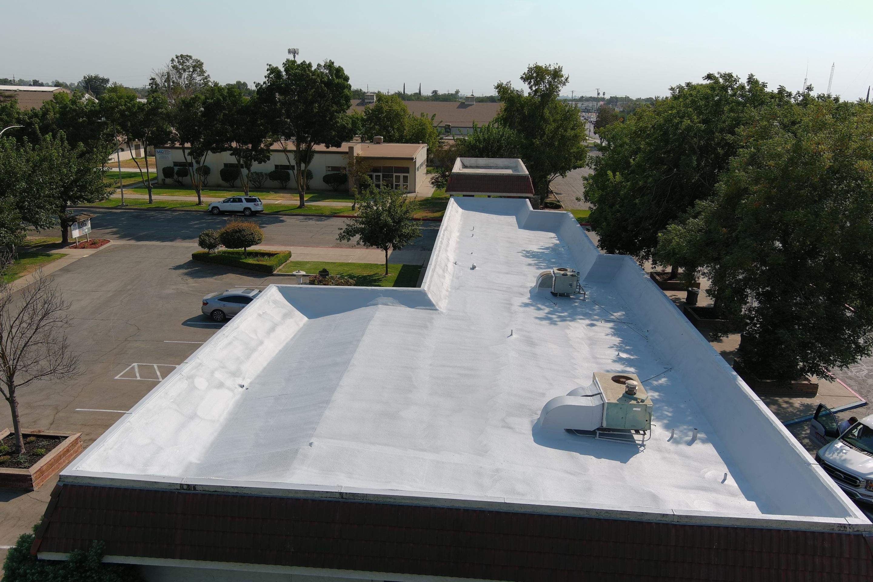 Commercial Roofing Installation using General Coatings acrylic coatings and spray foam by Straight Edge Roofing Inc