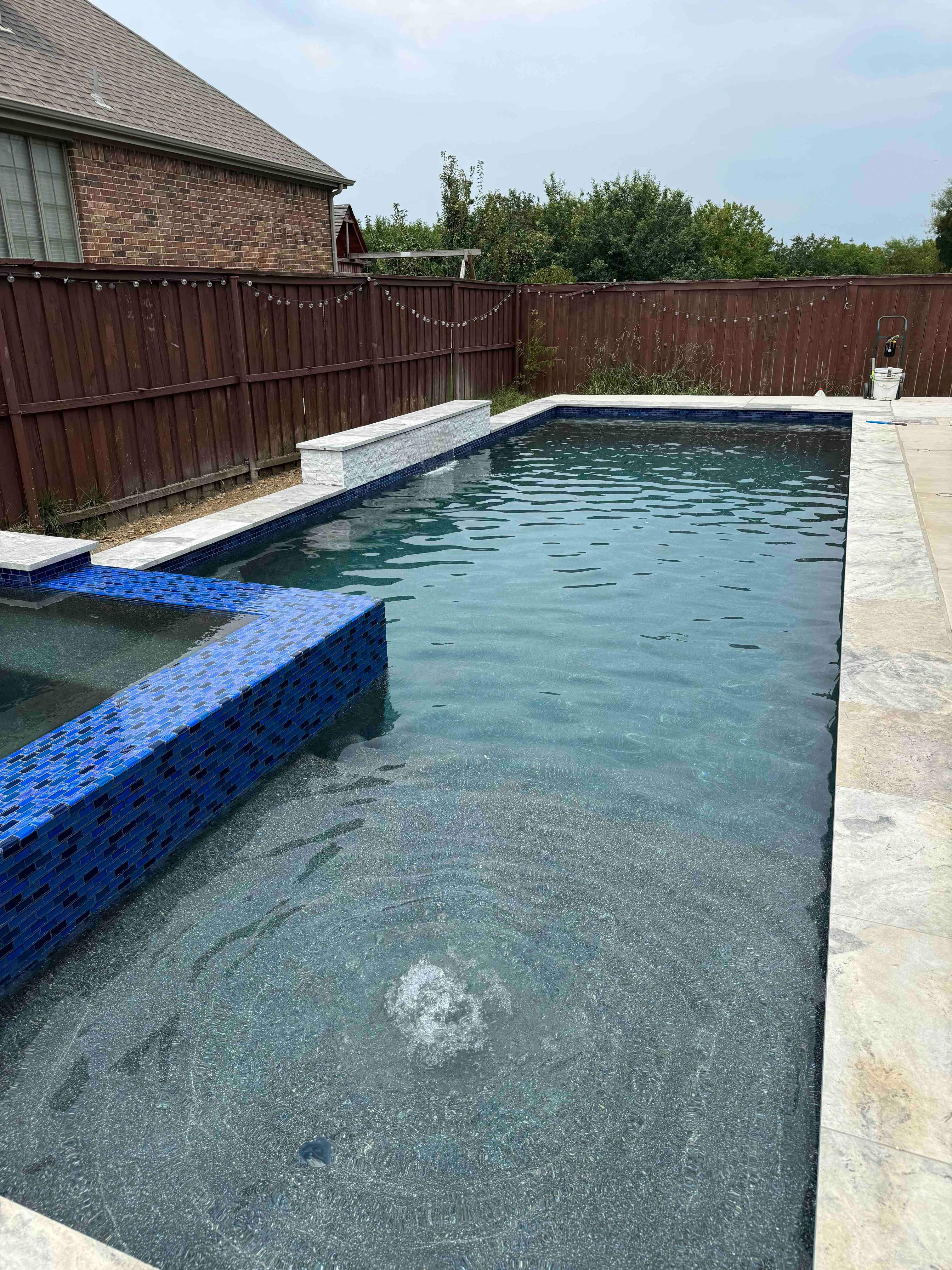 Freeform Pool with Raised Spa and Rock Waterfall by Pinnacle Pools and Spas - DFW