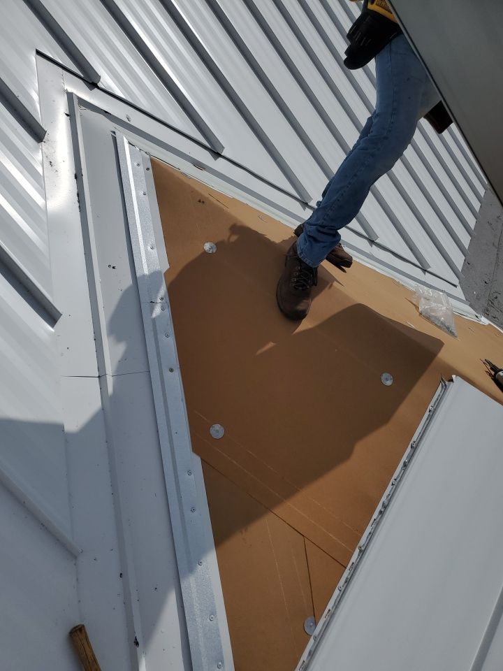 Residential Roofing Installation using 1.5" Nail Strip 24ga Solar White Kynar Coated Standing Seam Metal Panels by Morton Roofing, Inc.